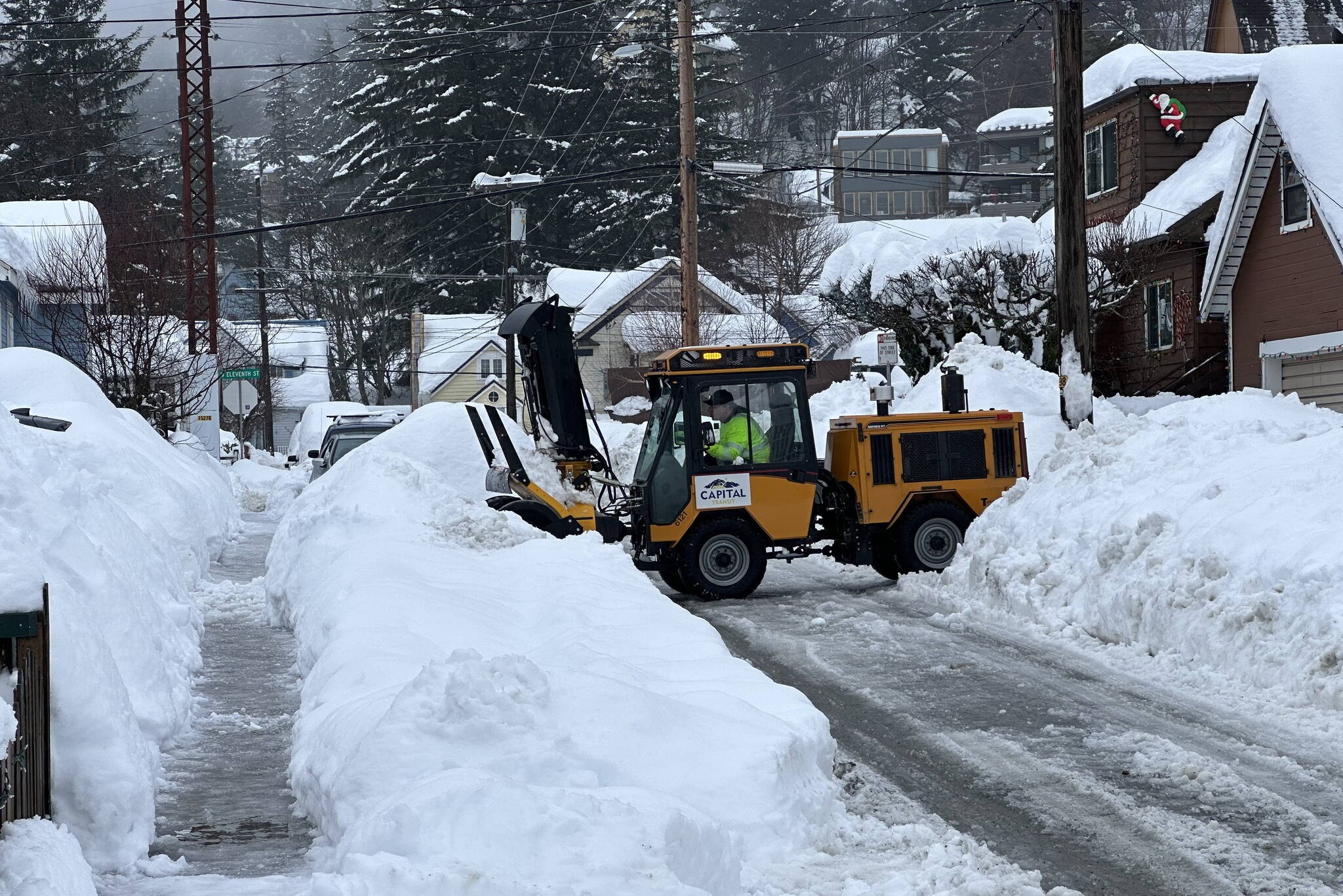 A city worker clears streets in downtown Juneau following this week’s snowstorm. (City and Borough of Juneau photo)