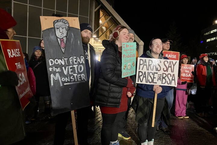 People carry signs at a Juneau rally in favor of an increase to the amount the government pays schools per student on Monday. (Photo by Claire Stremple/Alaska Beacon)