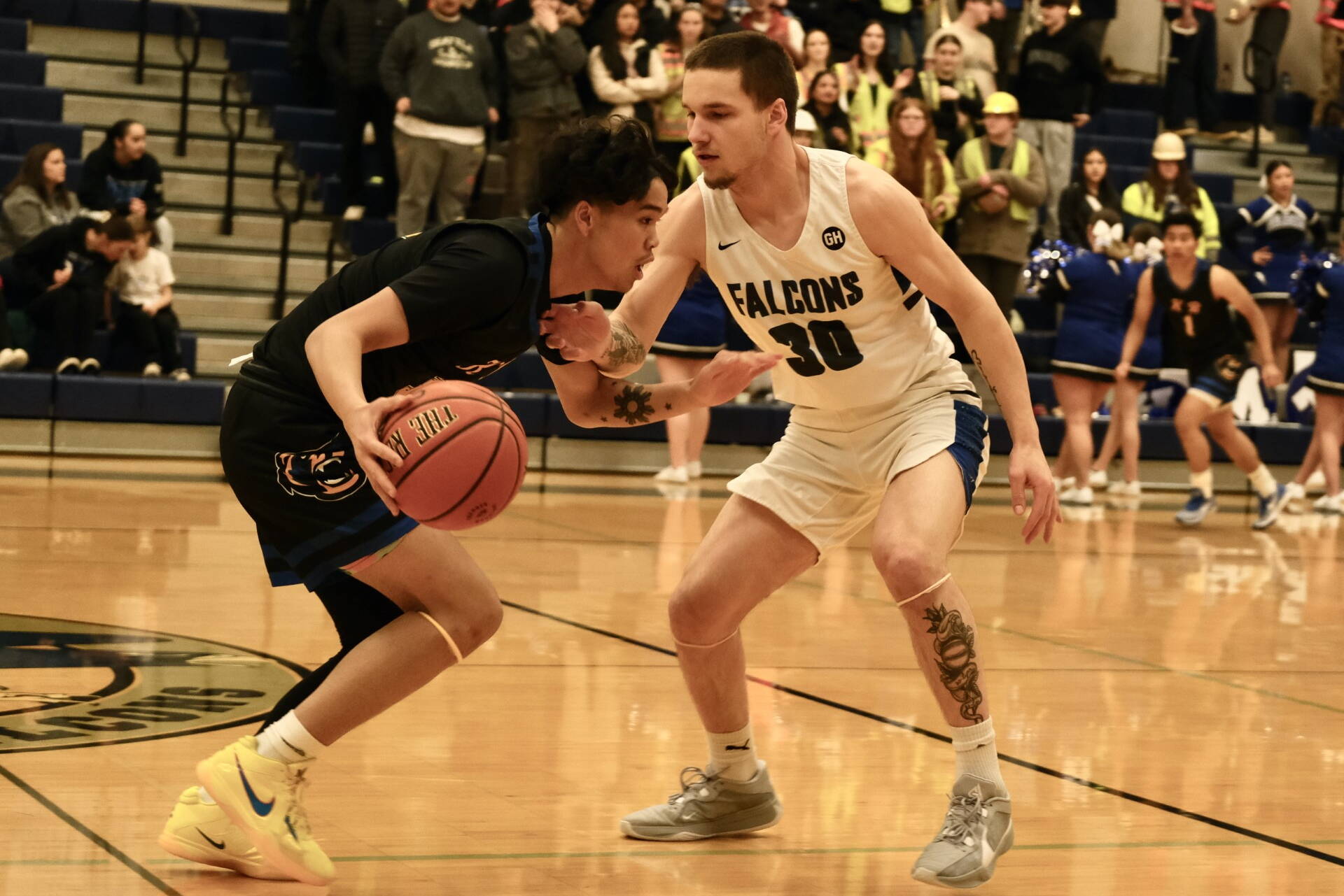 Thunder Mountain senior Thomas Baxter (30) defends Kodiak junior Kelly Ticman during the Falcons 71-49 home win over the Bears, Thursday at the Thunderdome. (Klas Stolpe / For the Juneau Empire)