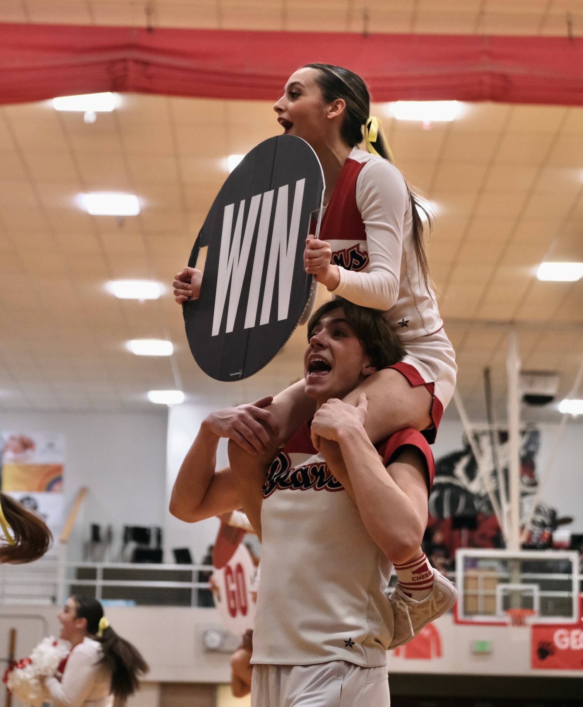 Members of the Juneau-Douglas High School: Yadaa.at Kalé cheer squad show their spirit during Saturday’s Crimson Bears basketball game against Kodiak. (Klas Stolpe/For the Juneau Empire)