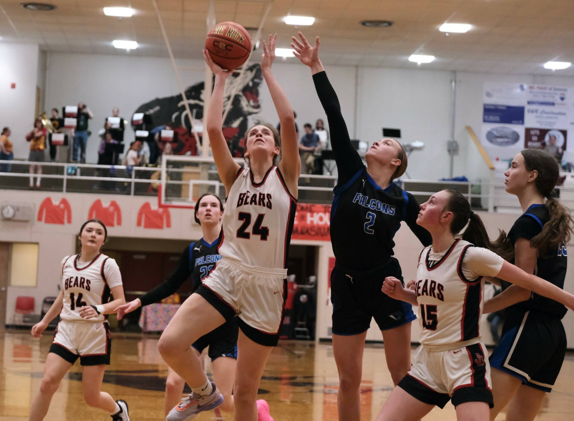 Juneau-Douglas High School: Yadaa.at Kalé senior Mila Hargrave (24) shoots under pressure from Thunder Mountain High School senior Ashlyn Gates (2) as JDHS sophomore Gwen Nizich (15) blocks out TMHS junior Cailynn Baxter (23) during the Crimson Bears 42-28 loss to the Falcons on Saturday at the George Houston Gymnasium. (Klas Stolpe/For the Juneau Empire)