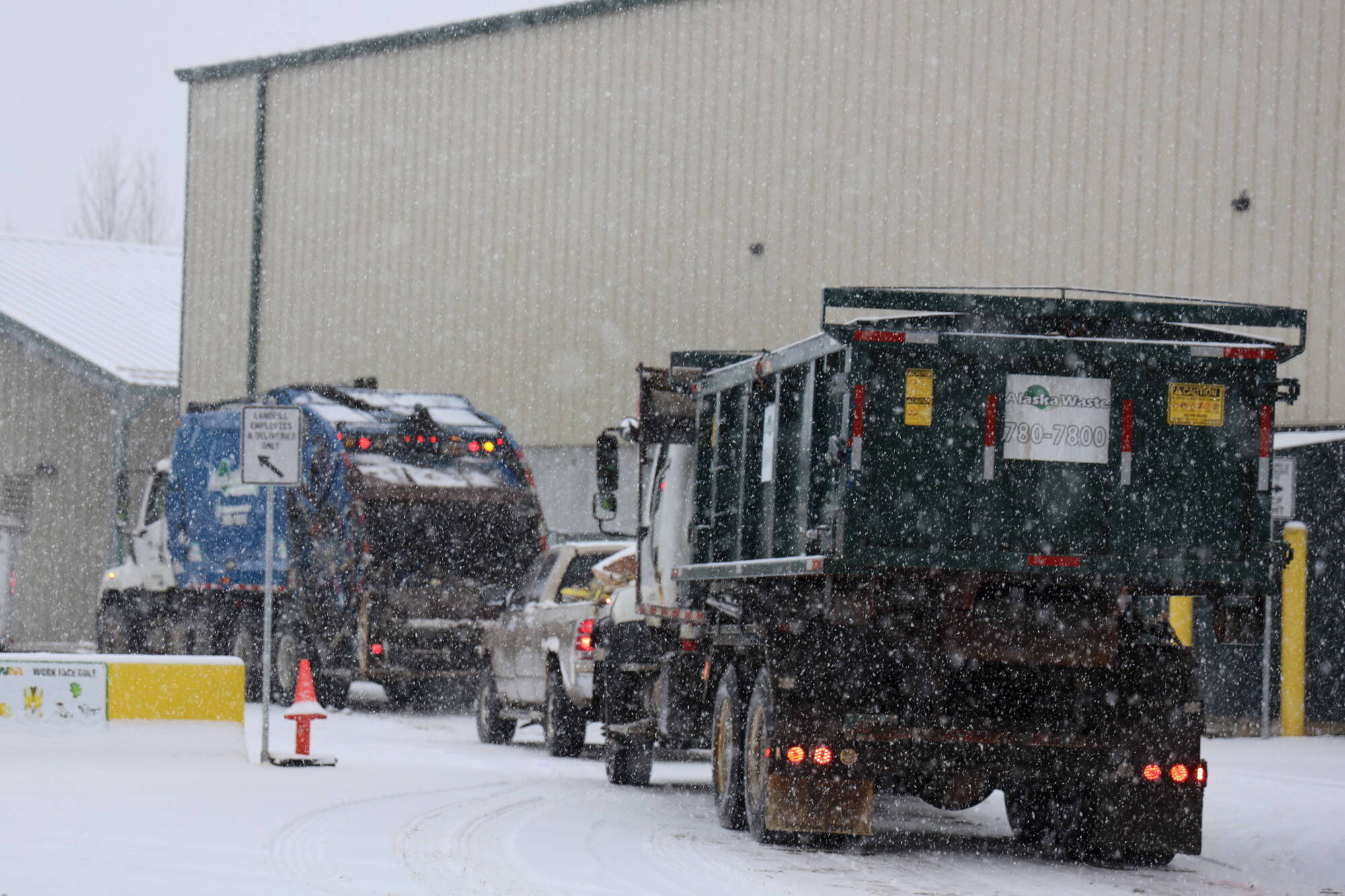 Multiple vehicles line up at the entrance of Waste Management’s Capitol Disposal Landfill in Lemon Creek on Jan. 30, 2023. (Clarise Larson / Juneau Empire file photo)