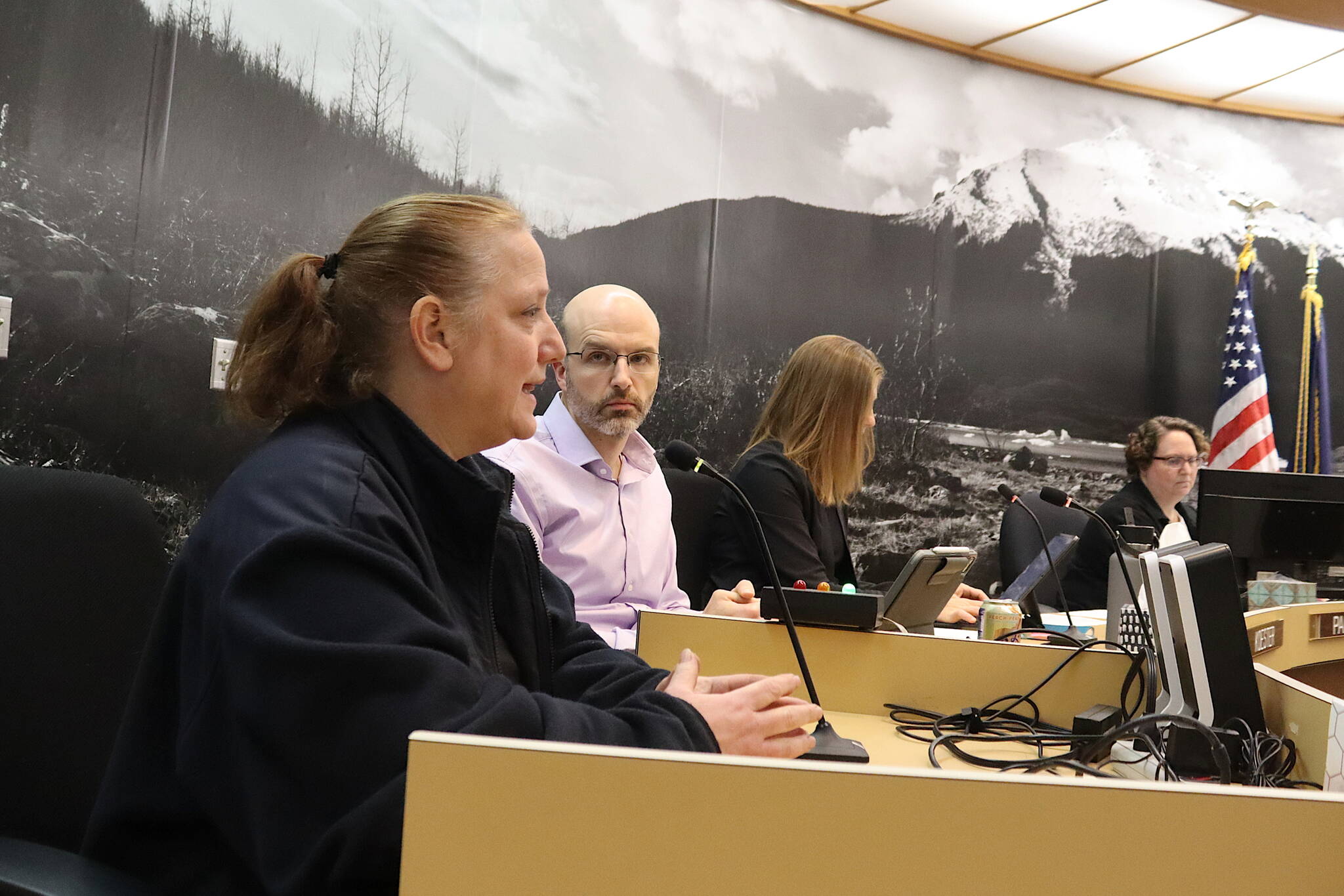 Venietia Bingham, owner of V’s Cellar Door, testifies in opposition to a resolution seeking to nearly double the number of licenses for establishments allowed to serve alcohol during a Juneau Assembly meeting on Monday night. (Mark Sabbatini / Juneau Empire)