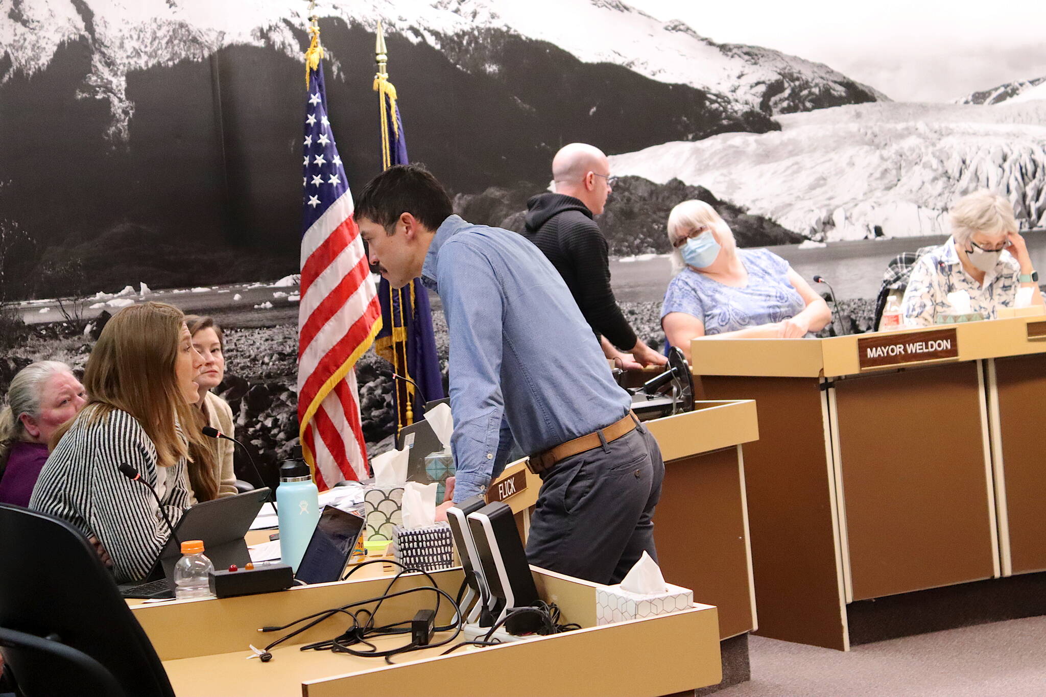 Juneau Assembly members and city administrators confer during a finance committee meeting Wednesday night about specific wording for portions of a proposed financial bailout package for the Juneau School District. (Mark Sabbatini / Juneau Empire)