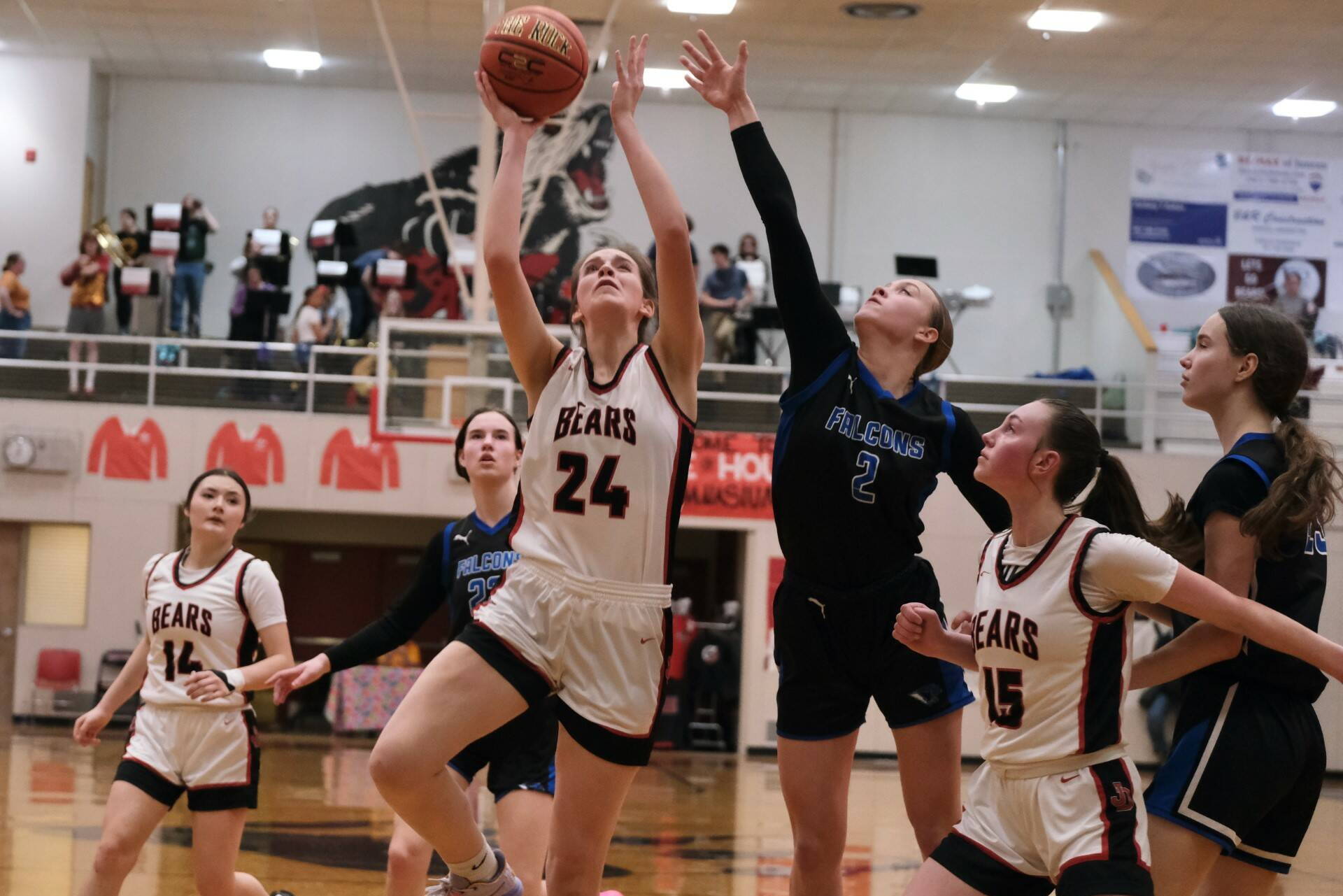 Juneau-Douglas High School: Yadaa.at Kalé senior Mila Hargrave (24) shoots under pressure from Thunder Mountain High School senior Ashlyn Gates (2) as JDHS sophomore Gwen Nizich (15) blocks out TMHS junior Cailynn Baxter (23) during the Crimson Bears 42-28 loss to the Falcons on Feb. 3 at the George Houston Gymnasium. The two teams split games during the weekend. (Klas Stolpe/Juneau Empire file photo)