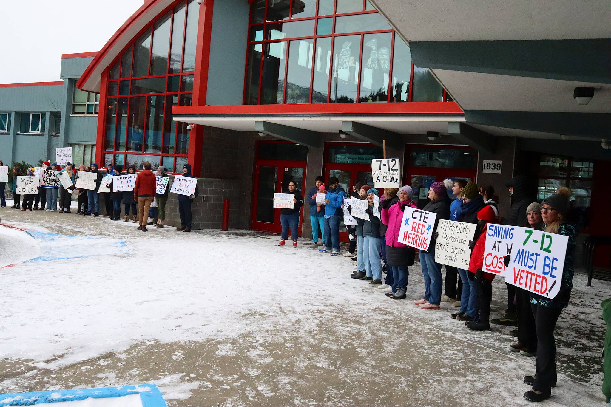 Students, parents and teachers rally outside Juneau-Douglas High School: Yadaa.at Kalé prior to a school board meeting Tuesday, seeking a change in the board’s decision to consolidate Juneau’s two high schools beginning with the next school year. (Mark Sabbatini / Juneau Empire)