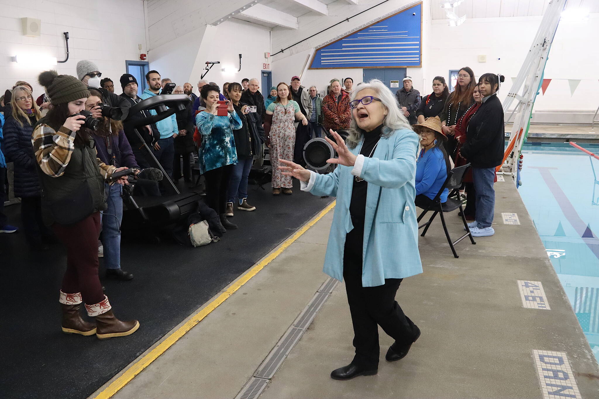 Liana Wallace offers a water blessing during a ribbon-cutting ceremony for the Augustus G. Brown Swimming Pool on Friday following nearly a year of renovations. The pool is scheduled to reopen for public use on Tuesday. (Mark Sabbatini / Juneau Empire)