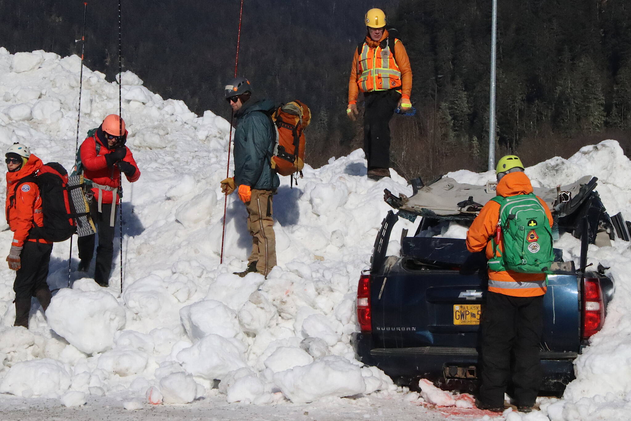 Emergency response officials probe the wreckage of a simulated avalanche site during a training exercise in Lemon Creek on Saturday. (Mark Sabbatini / Juneau Empire)