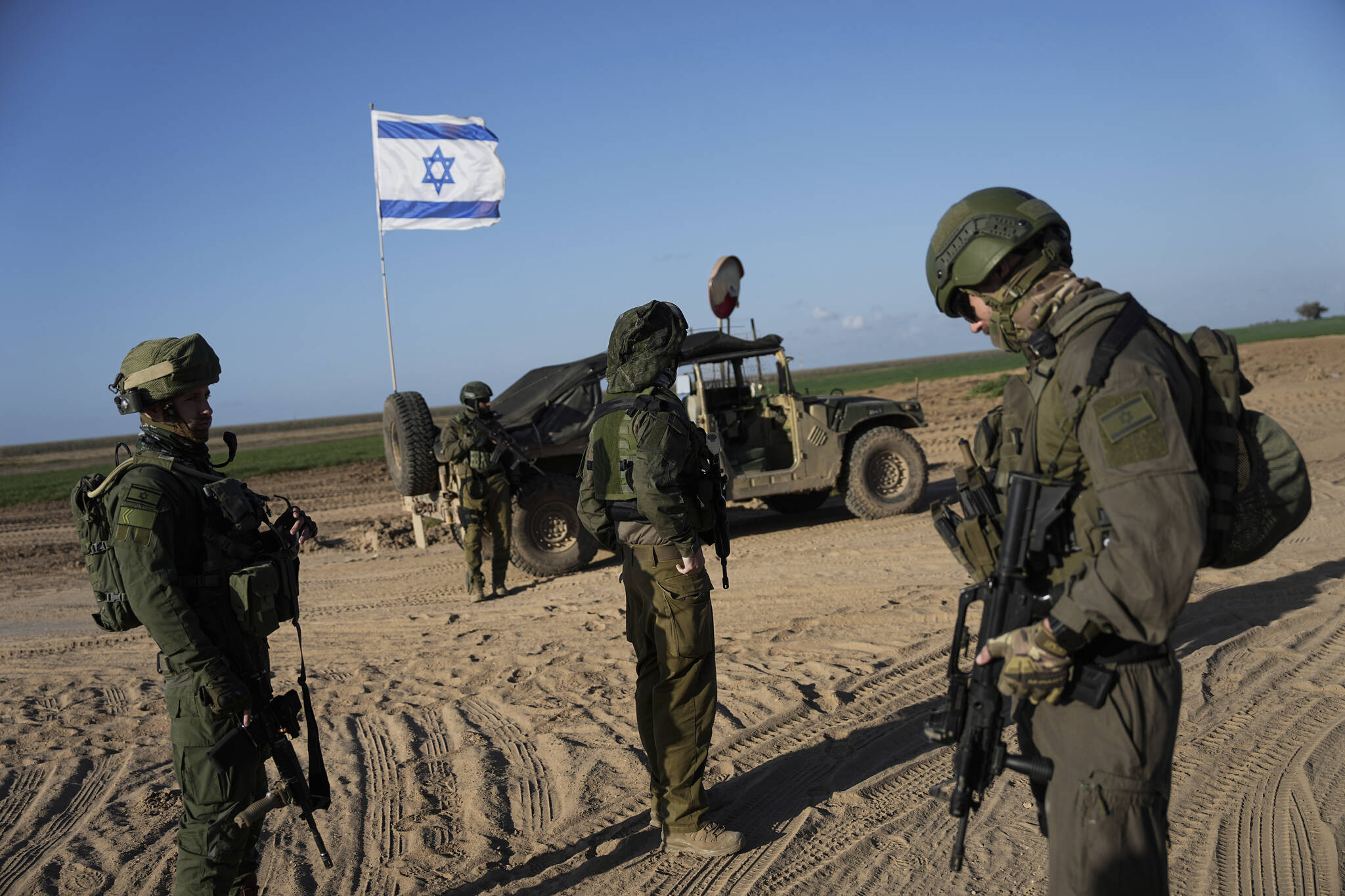 Israeli soldiers are seen near the Gaza Strip border in southern Israel on Monday. The army is battling Palestinian militants across Gaza in the war ignited by Hamas’ Oct. 7 attack into Israel. (AP Photo/Ohad Zwigenberg)