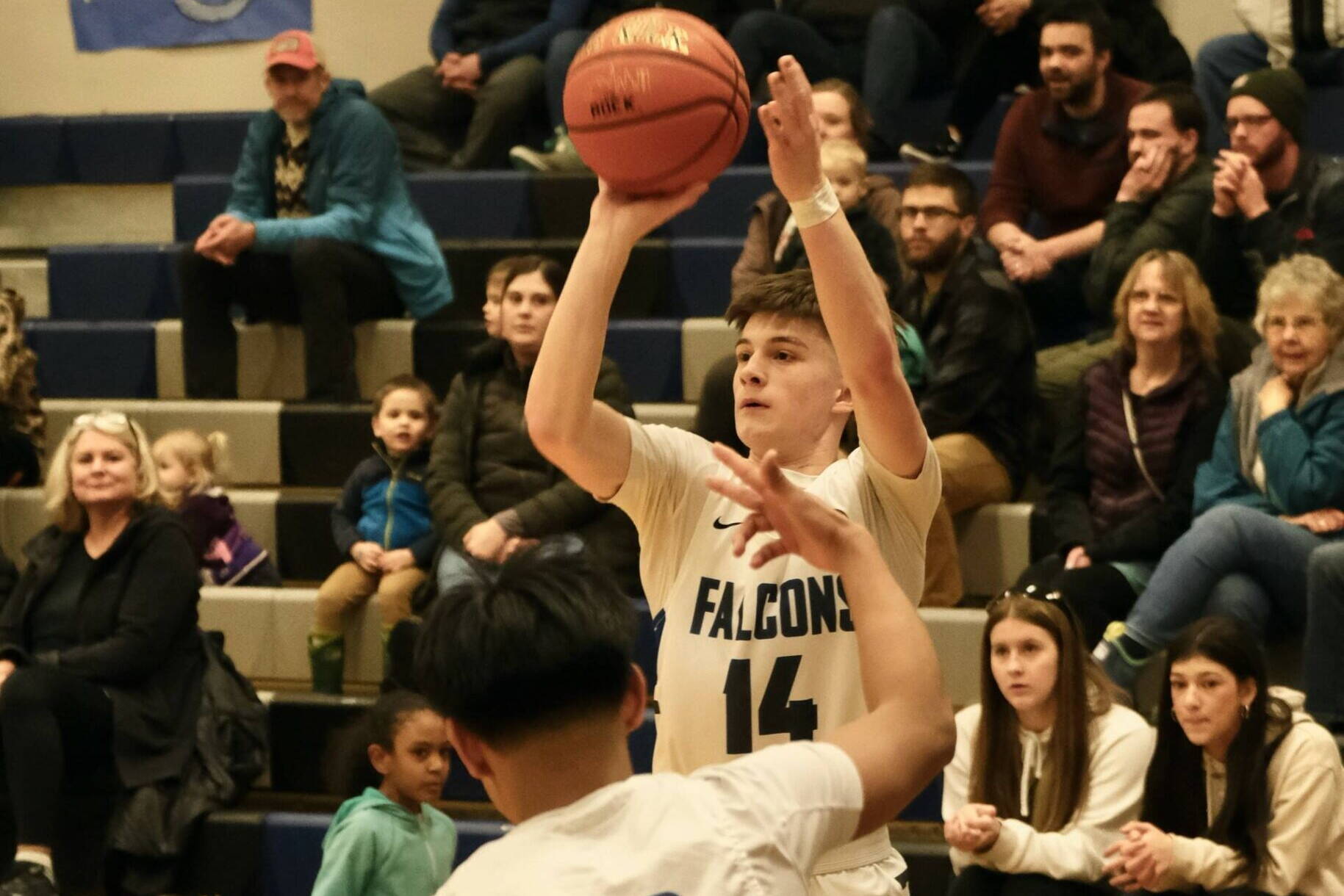 Thunder Mountain High School senior Samuel Lockhart (14) shoots a 3-pointer during a Feb. 1 game at TMHS. (Klas Stolpe / Juneau Empire file photo)