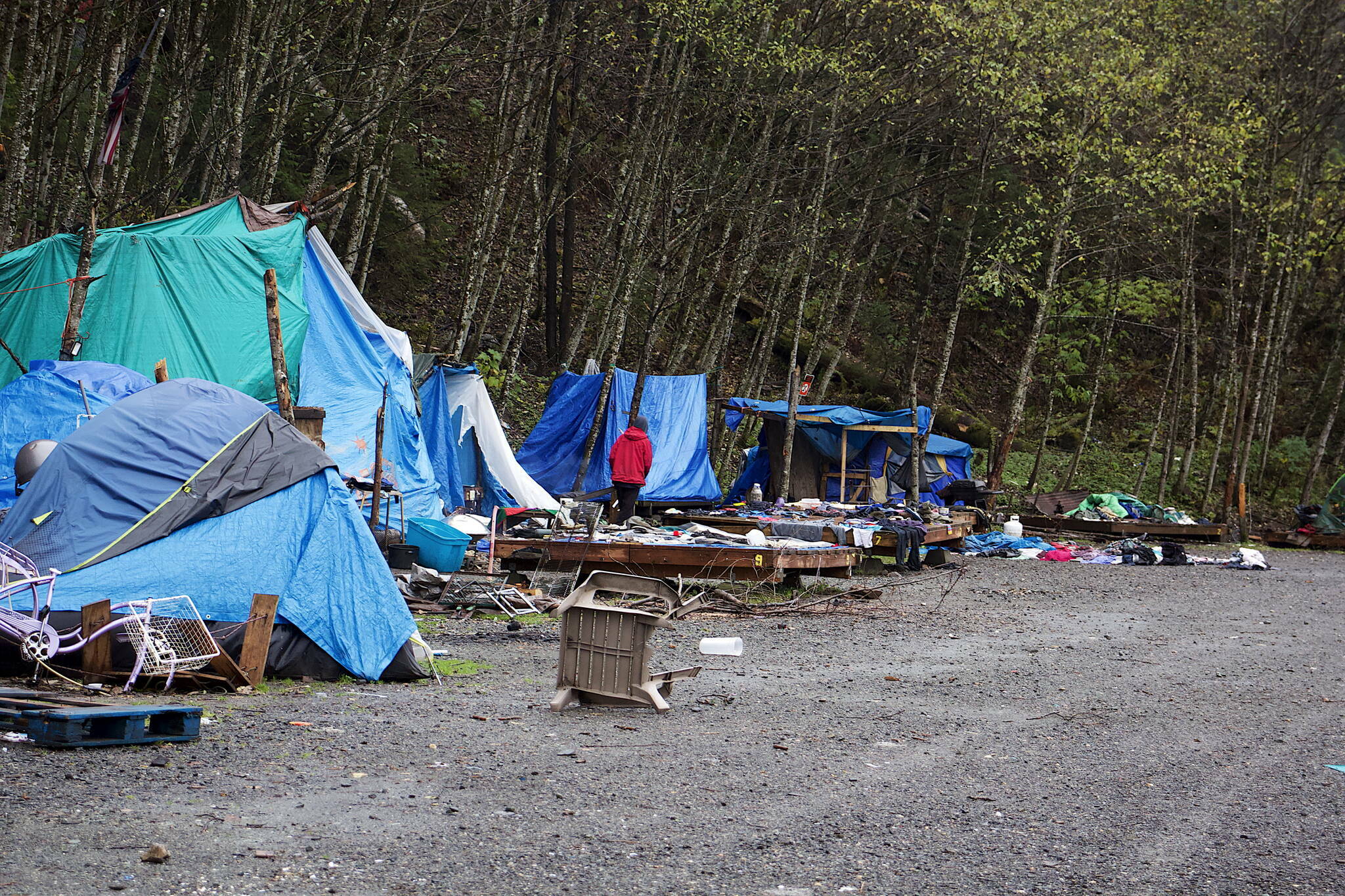 An assortment of furniture, clothing and other household items are exposed to the elements at Mill Campground after being left behind by residents who departed ahead of the campground’s closing last October. (Mark Sabbatini / Juneau Empire file photo)