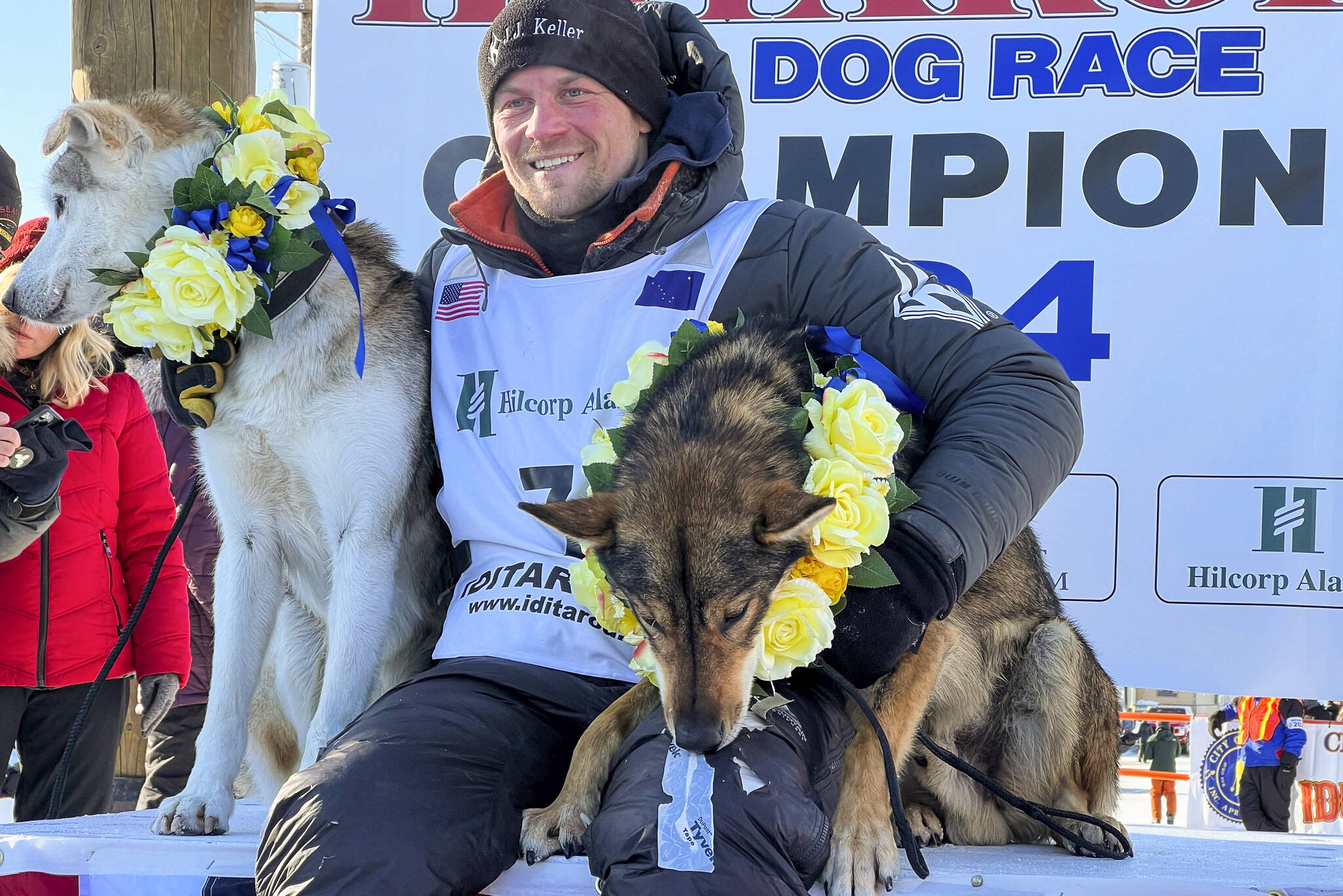Dallas Seavey sits with his lead dogs Sebastian, left, and Aero after his sixth Iditarod Trail Sled Dog Race win on Tuesday in Nome. (Anne Raup/Anchorage Daily News via AP)