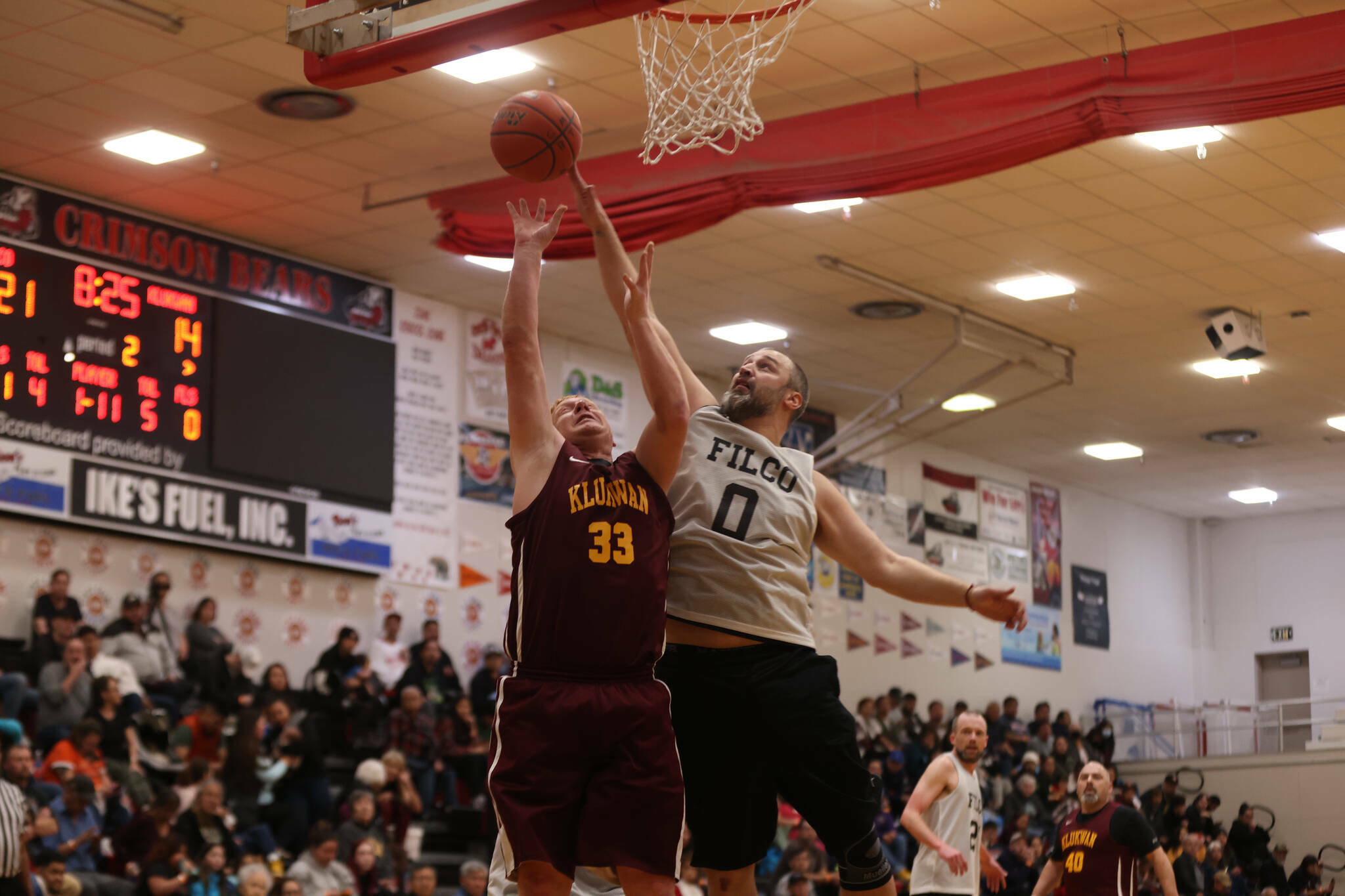 Filcom’s Ray Zimmer (0) blocks a shot from Klukwan’s Jess McGraw in the first half of the Juneau Lions Club 74th Gold Medal Basketball Tournament C Bracket Championship Game on Saturday, March 26, 2023, in Juneau-Douglas High School: Yadaa.at Kalé’s gymnasium. (Ben Hohenstatt / Juneau Empire file photo)