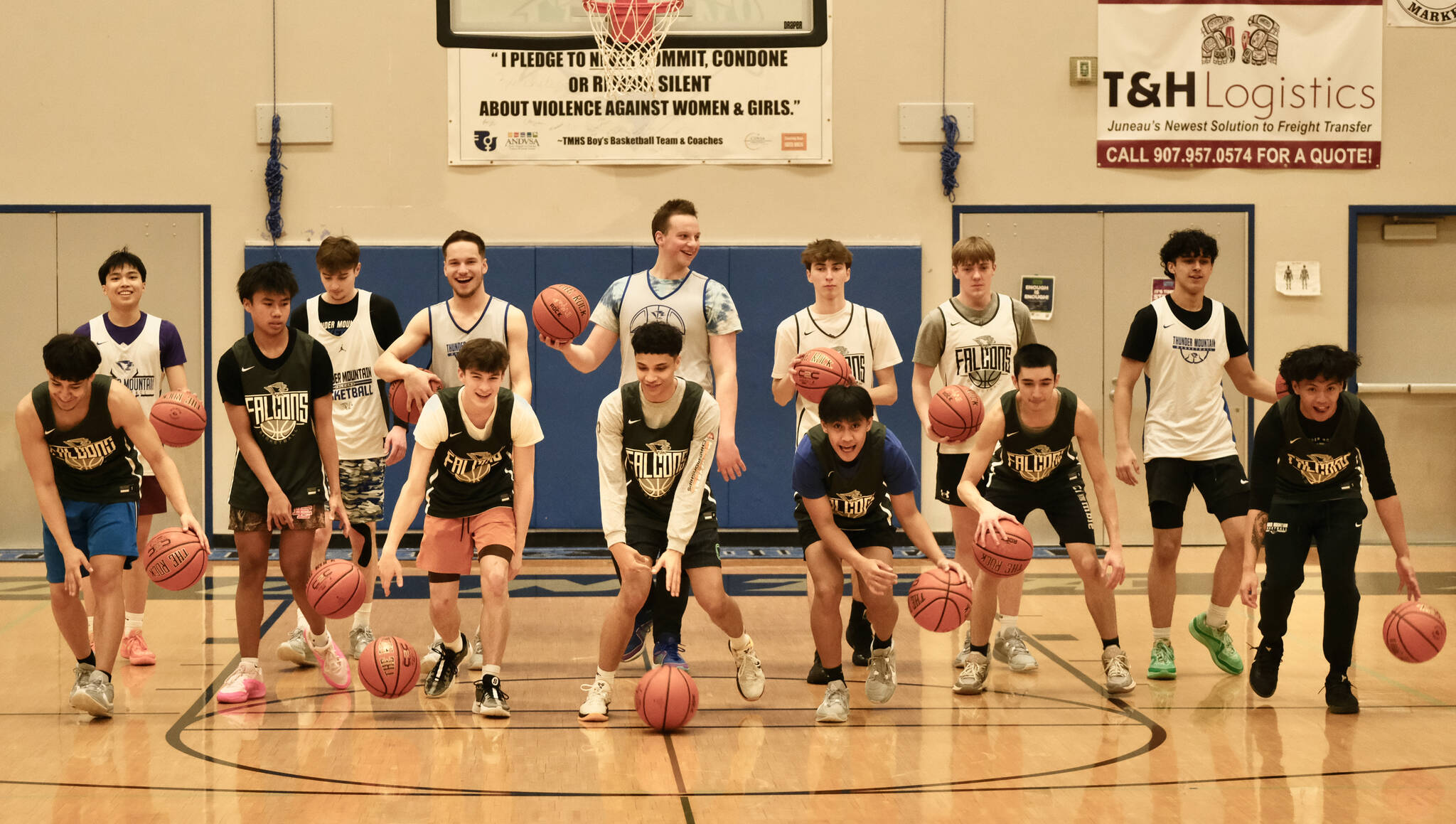 The Thunder Mountain High School Falcons Region V champion boys basketball team pose for a photo during practice at the Thunderdome on Friday. The Falcons begin state tournament play Wednesday at Anchorage’s Alaska Airlines Center. (Klas Stolpe / For the Juneau Empire)