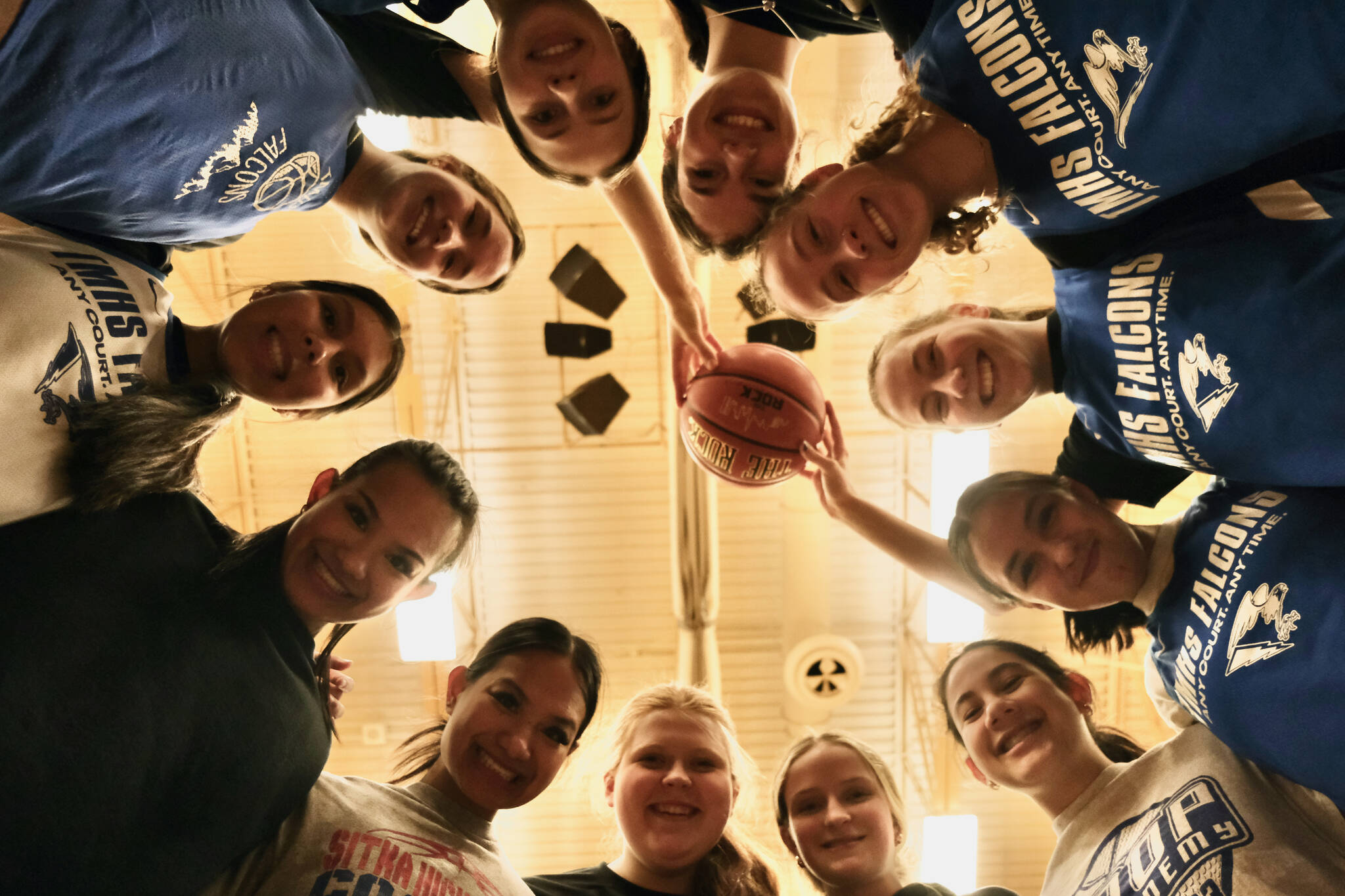 The Thunder Mountain High School Falcons Region V champion girls basketball team pose for a photo during practice at the Thunderdome on Friday. The Falcons begin state tournament play Wednesday at Anchorage’s Alaska Airlines Center. (Klas Stolpe / For the Juneau Empire)