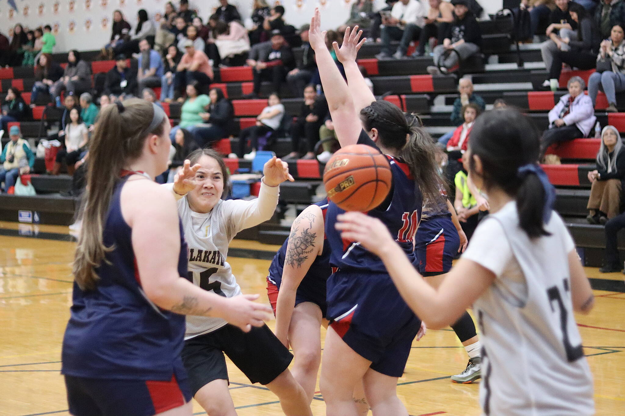 Metlakatla’s Drena Hayward (#15) passes the ball to a teammate in their opening game against Yakutat during the 75th Gold Medal Basketball Tournament on Sunday morning at Juneau-Douglas High School: Yadaa.at Kalé. (Mark Sabbatini / Juneau Empire)