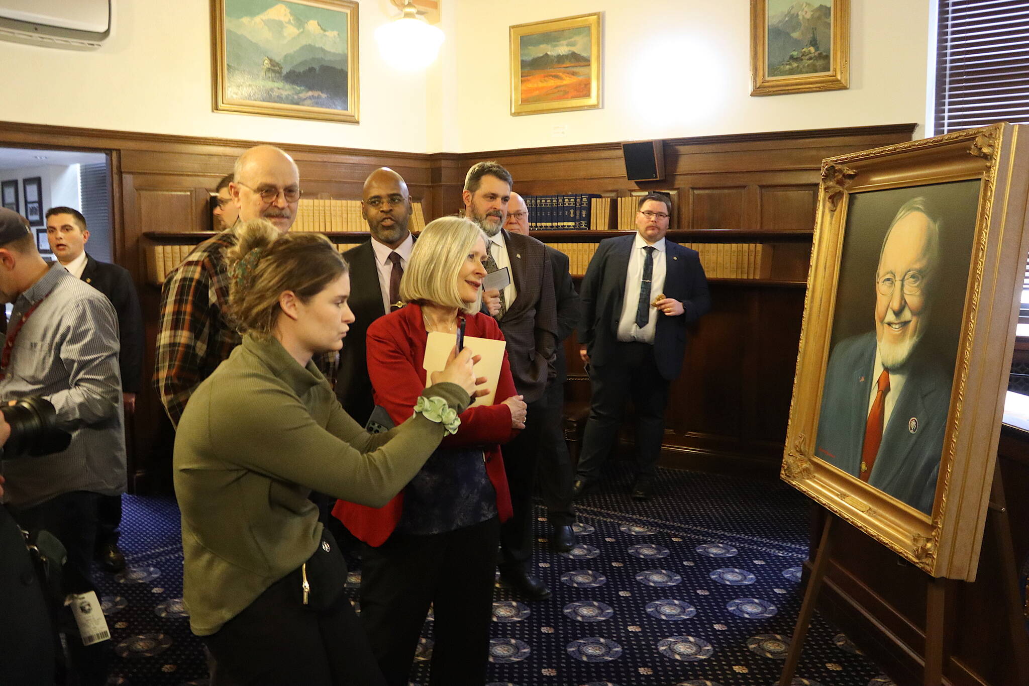 Legislators and other guests view a newly unveiled portrait of the late Congressman Don Young on Monday, the second anniversary of his death, to be in the Alaska State Capitol. (Mark Sabbatini / Juneau Empire)