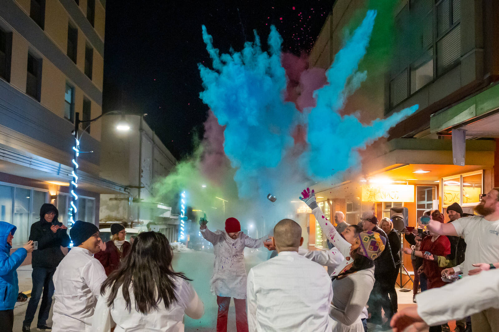 People throw cornstarch of various colors at each other during a Holi celebration in downtown Juneau in 2023. (Photo by Cody Bennett)