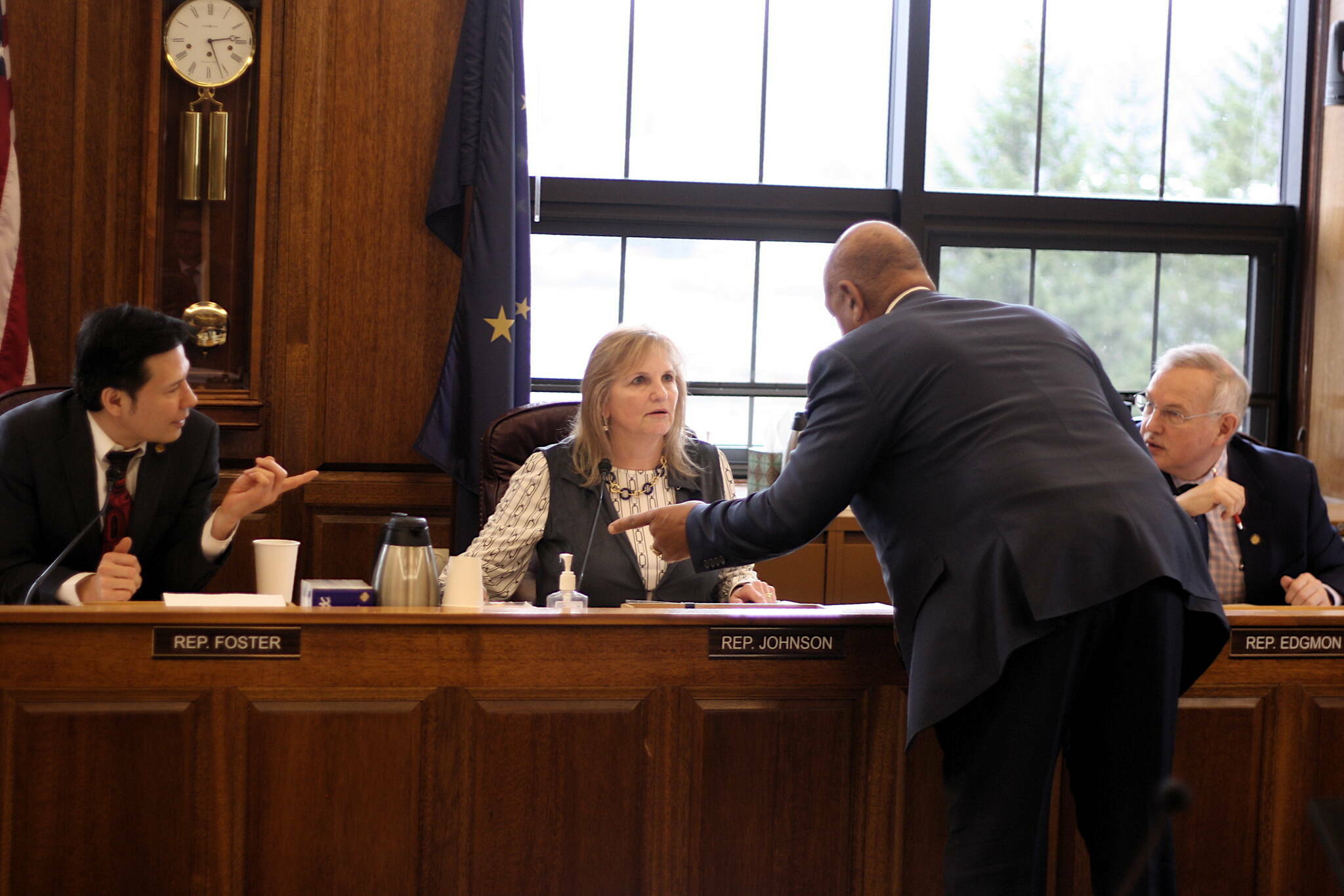 Rep. DeLena Johnson, R-Palmer, center, discusses budget legislation with her chief of staff, Remond Henderson, standing, and Reps. Neil Foster, D-Nome, left, and Bryce Edgmon, I-Dillingham on March 20, 2023. (Mark Sabbatini / Juneau Empire file photo)