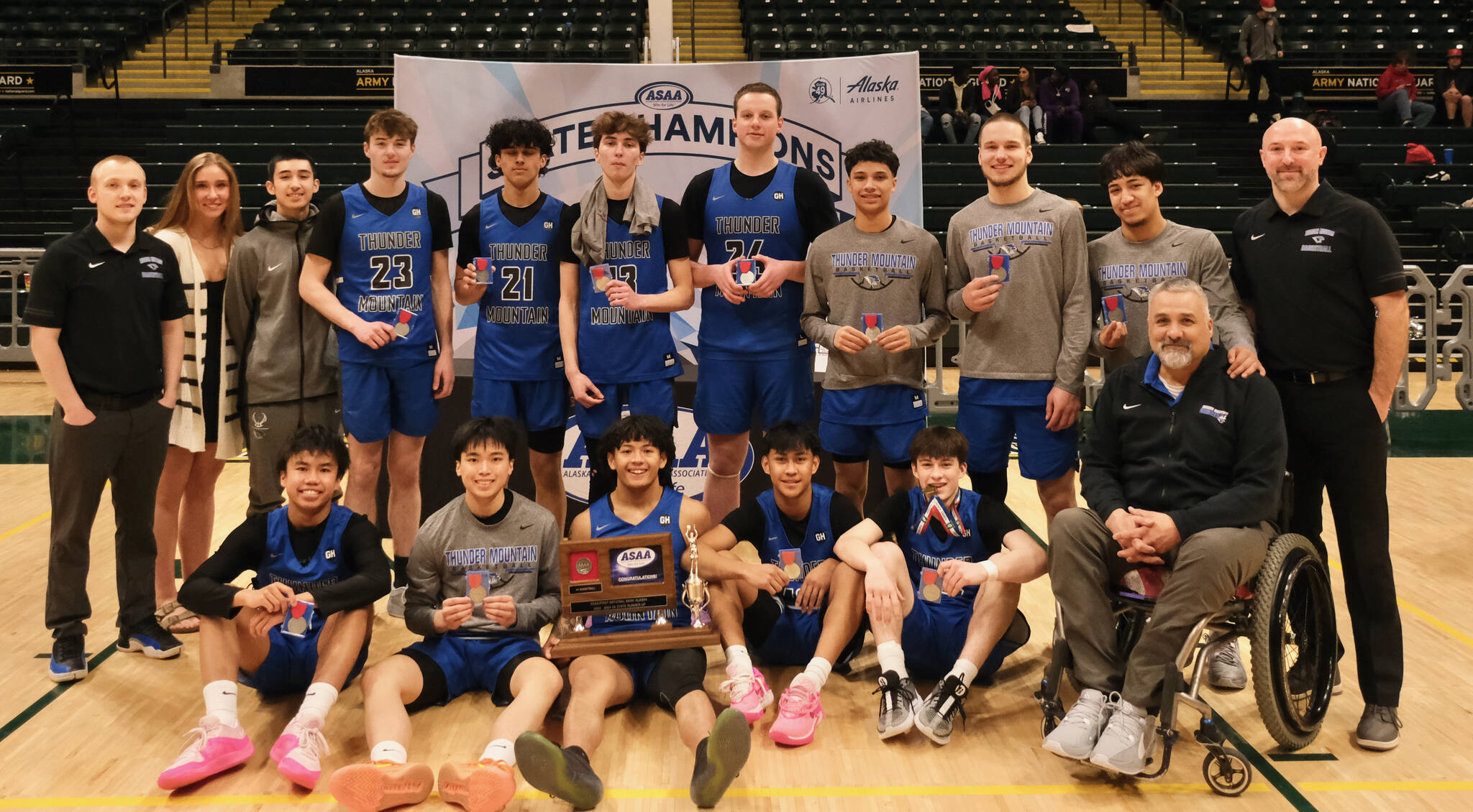 The Thunder Mountain Falcons boys basketball team poses with their runner-up trophy after falling to East Anchorage 60-34 in the title game of the 2024 ASAA March Madness Alaska 4A Boys Basketball State Championship game on Saturday at Anchorage’s Alaska Airlines Center. (Klas Stolpe / For the Juneau Empire)