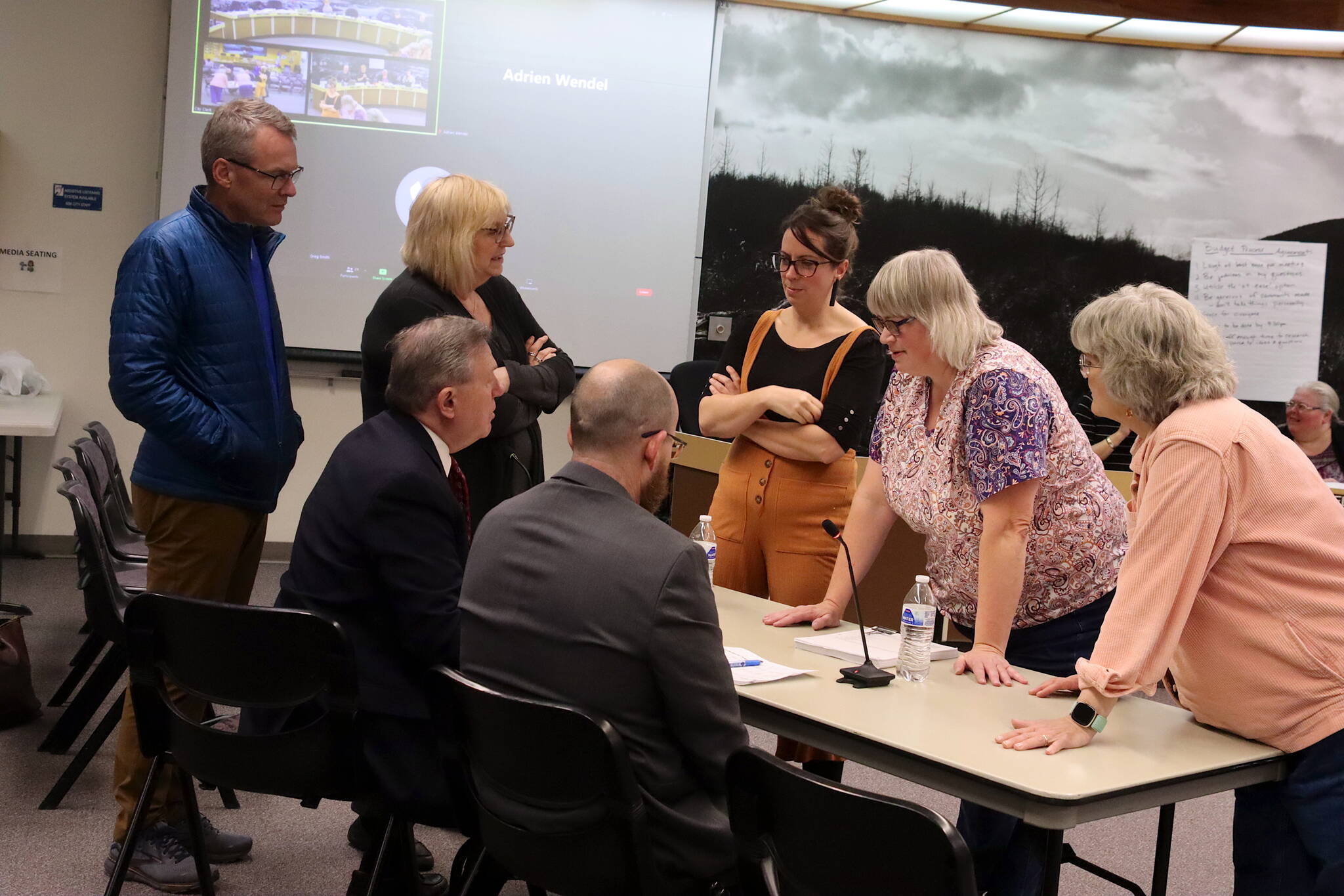 Juneau Assembly members confer with Bartlett Regional Hospital leaders during a break in an Assembly Finance Committee meeting Saturday. (Mark Sabbatini / Juneau Empire)