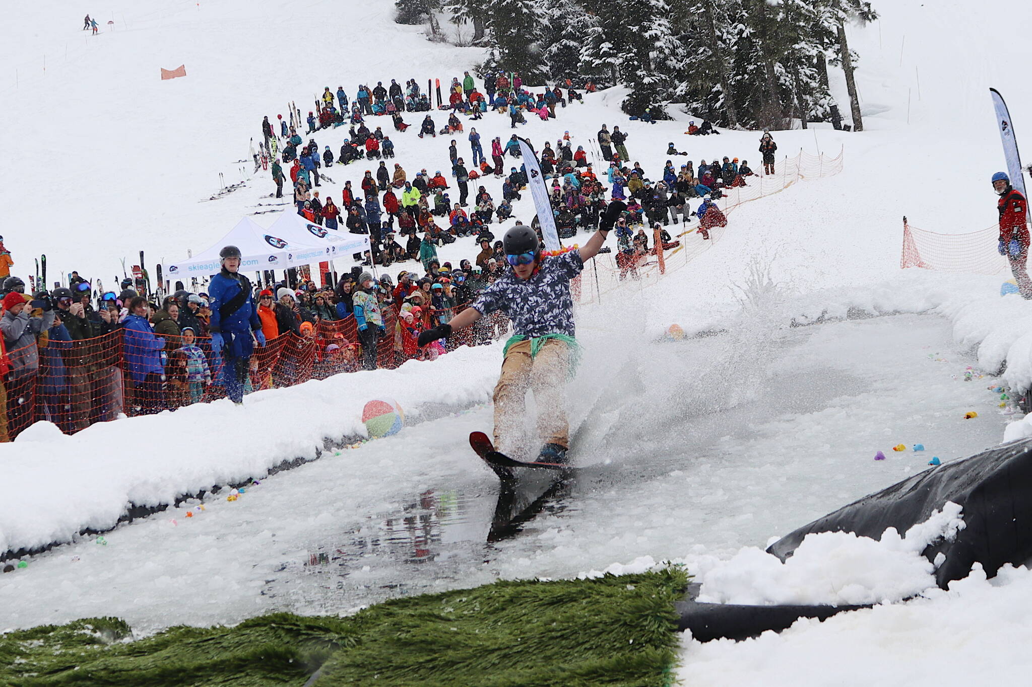 Elias Lowell, 15, balances his way to the end of the pond during the annual Slush Cup at Eaglecrest Ski Area on Sunday, the last day of what officials called and up-and-down season. (Mark Sabbatini / Juneau Empire)