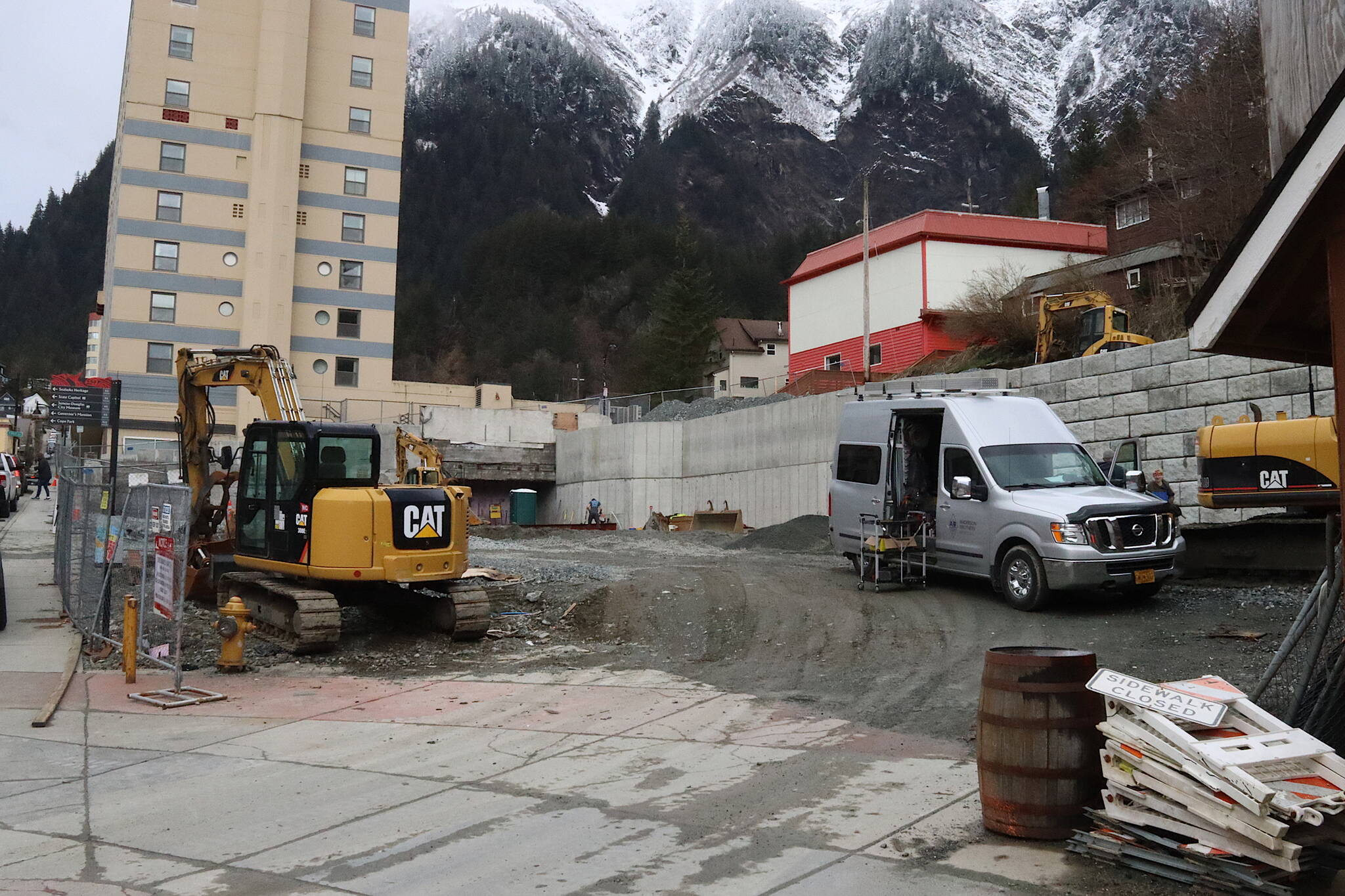 Construction workers work on retaining walls and other infrastructure Tuesday in preparation for an expanded three-season food court on South Franklin Street. The Juneau Planning Commission unanimously approved a conditional use permit for the project, some of which occupies the space where the historic Elks Lodge stood until it was demolished last year. (Mark Sabbatini / Juneau Empire)