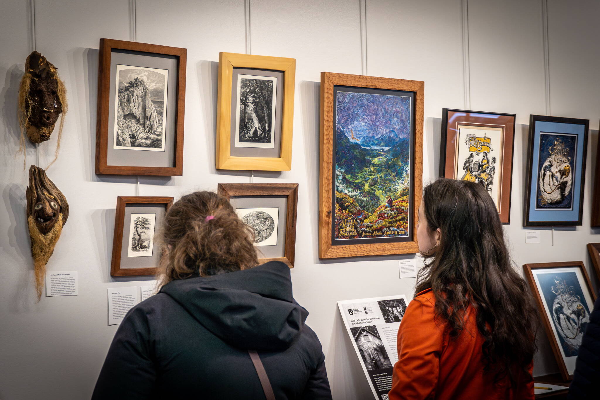 Visitors look at an art exhibit by Eric and Pam Bealer at Alaska Robotics that is on display until Sunday. (Photo courtesy of the Sitka Conservation Society)