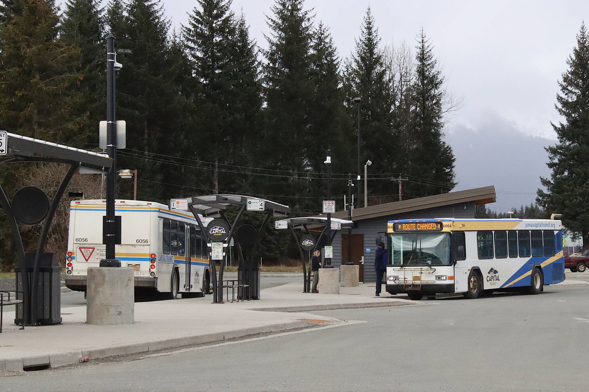 Capital Transit buses stop at the Valley Transit Center on Thursday. Two bus routes serving areas of the Mendenhall Valley and near the airport will temporarily be discontinued starting April 22 due to lack of staff. (Mark Sabbatini / Juneau Empire)