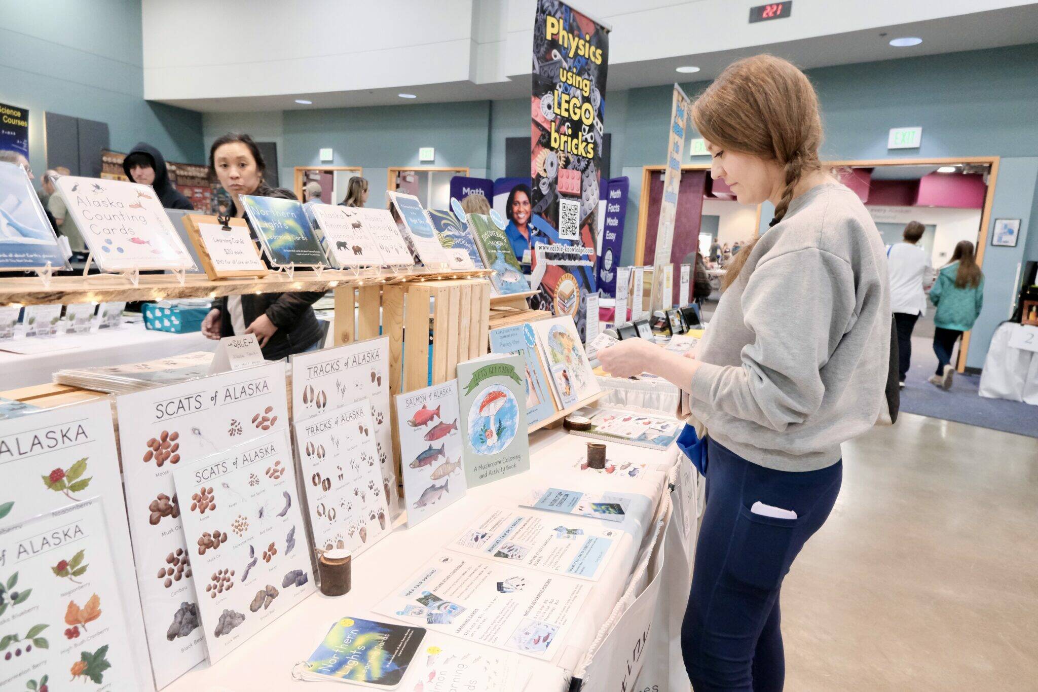 Danielle Brubaker shops for homeschool materials at the IDEA Homeschool Curriculum Fair in Anchorage on Thursday. A court ruling struck down the part of Alaska law that allows correspondence school families to receive money for such purchases. (Claire Stremple/Alaska Beacon)