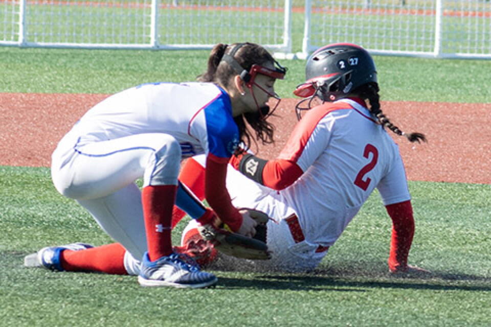 Juneau-Douglas base runner Tristan Oliva is safe at second base as Sitka senior Nai’a Nelson defends, Saturday at Moller Field. Juneau won the softball game, part of a three-day home tourney in Sitka. (Sitka Sentinel photo)