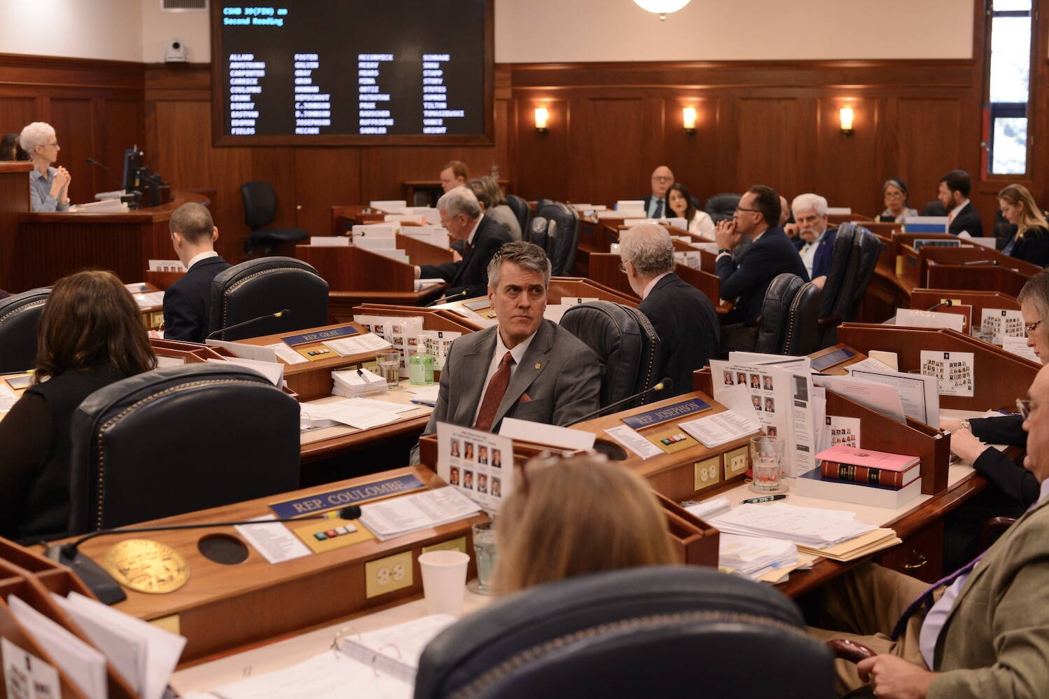 Rep. Andrew Gray, D-Anchorage, turns to listen to a proposed amendment to the state budget on Monday, April 3, 2023, at the Alaska State Capitol. (James Brooks/Alaska Beacon)