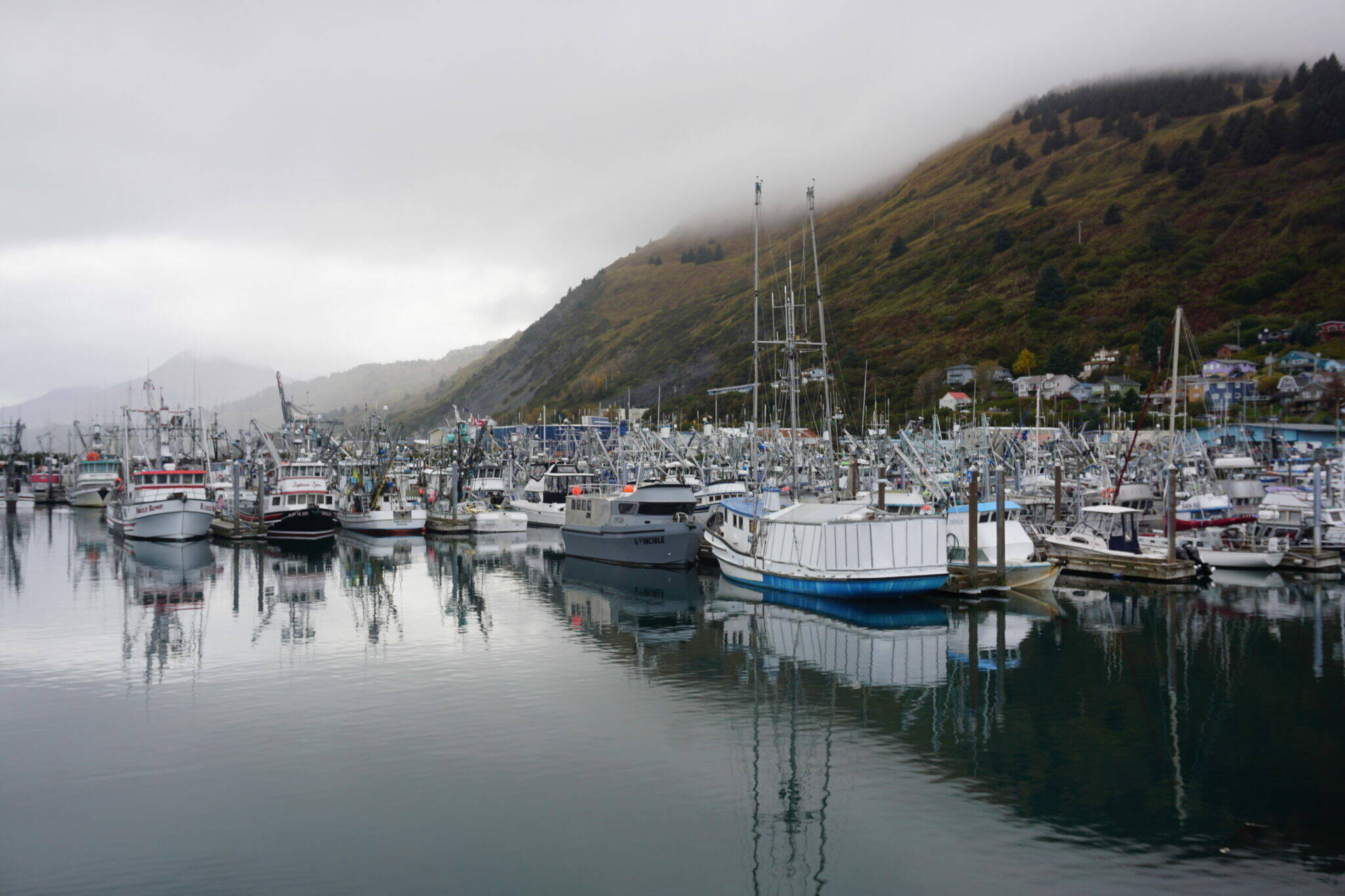 Low clouds hang over Kodiak’s St. Paul Harbor on Oct. 3, 2022. Kodiak is a hub for commercial fishing, an industry with an economic impact in Alaska of $6 billion a year in 2021 and 2022, according to a new report commissioned by the Alaska Seafood Marketing Institute. (Yereth Rosen/Alaska Beacon)