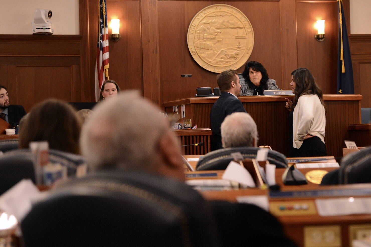Reps. Jesse Sumner, R-Wasilla, and Jamie Allard, R-Eagle River, talk to Speaker of the House Cathy Tilton, R-Wasilla, during a break in the Alaska House of Representatives floor session on Monday. (James Brooks/Alaska Beacon)