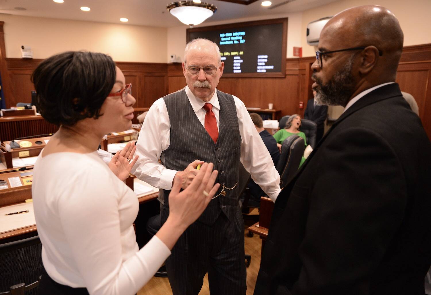 From left to right, Sens. Loki Tobin, D-Anchorage; Bert Stedman, R-Sitka; and David Wilson, R-Wasilla, discuss a proposed budget amendment on Wednesday. (James Brooks/Alaska Beacon)
