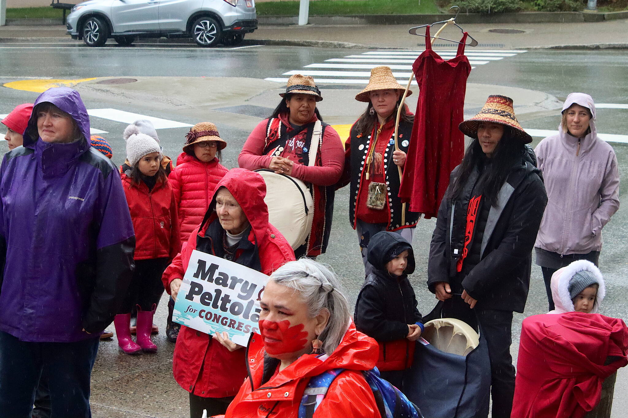 Red clothing is worn and displayed as a sign of a unified call for action during a rally in front of the Alaska State Capitol on Sunday to commemorate the annual Missing and Murdered Indigenous Persons Awareness Day. (Mark Sabbatini / Juneau Empire)