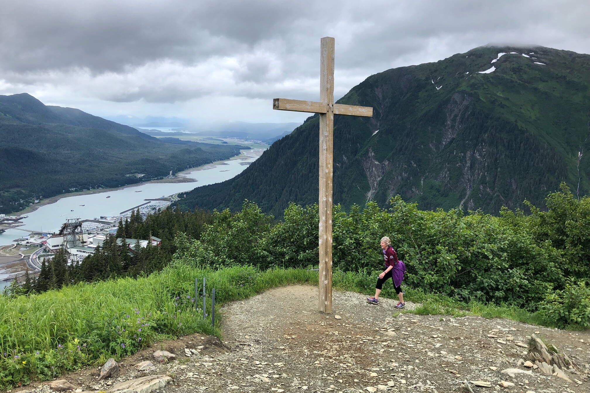 Hiker Linda Kruger reaches Father Brown’s Cross on Mount Roberts in this July 2020 photo. Kruger has organized the annual trail race to the cross for the past ten years. This year’s race is scheduled for Saturday, July 6, although the cross is no longer there. (Photo courtesy Jeff Gnass)