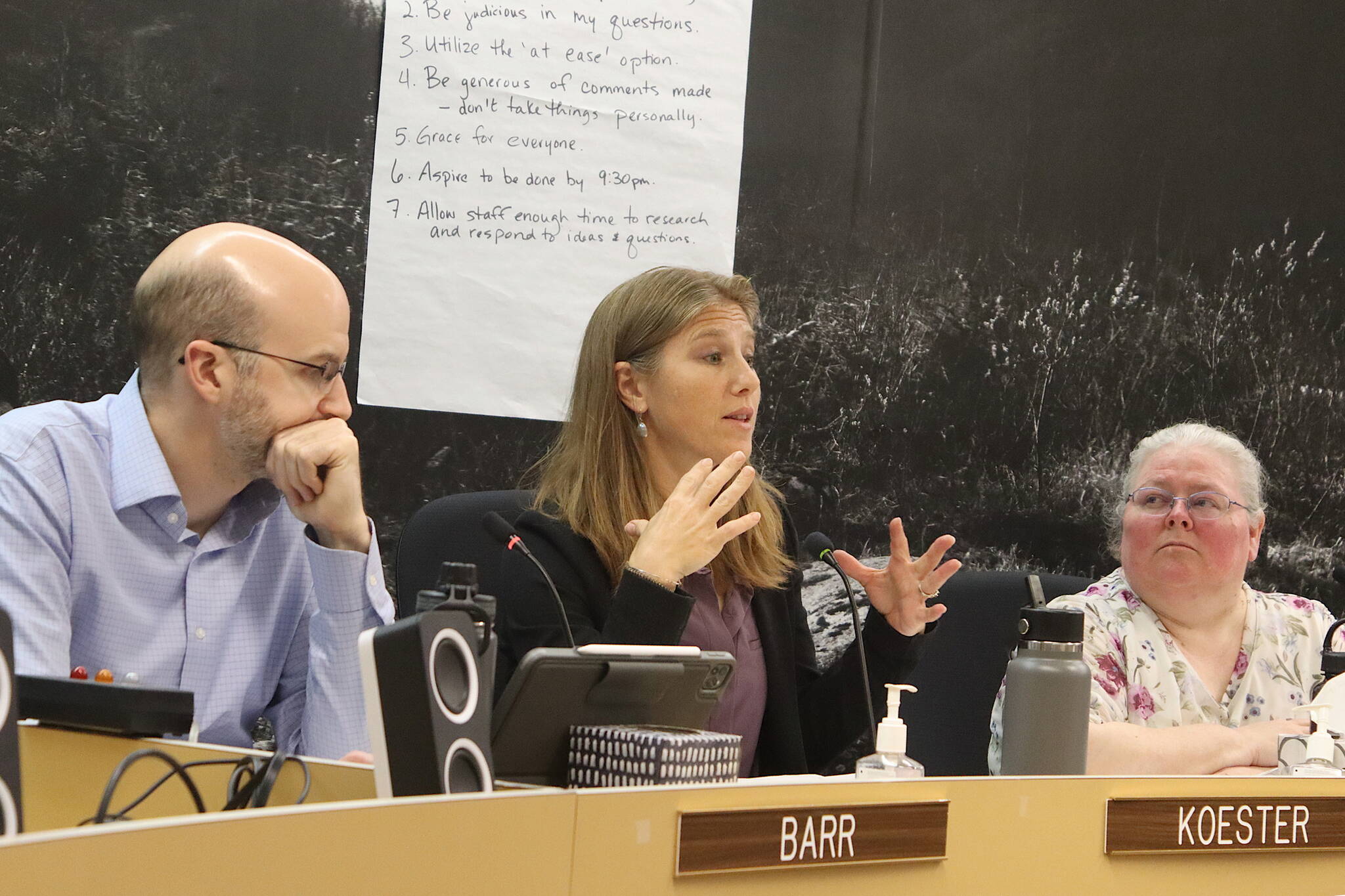 City Manager Katie Koester (center) explains options for a budget item to members of the Juneau Assembly’s Finance Committee during a meeting Wednesday night as Deputy City Manager Robert Barr and Finance Director Angie Flick listen. (Mark Sabbatini / Juneau Empire)