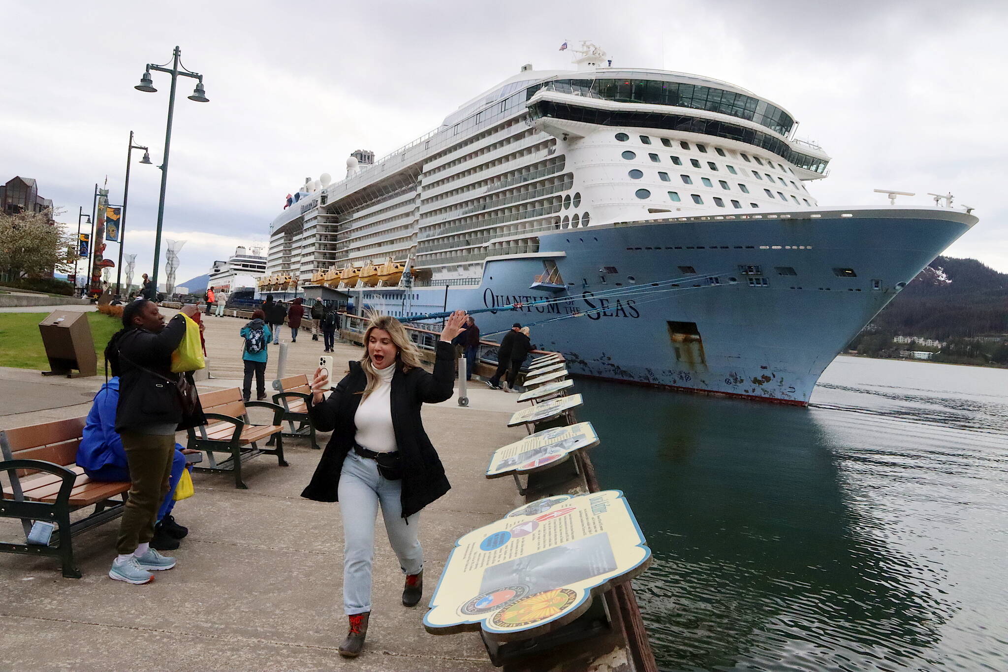 Jasmine Chavez, a crew member aboard the Quantum of the Seas cruise ship, waves to her family during a cell phone conversation after disembarking from the ship at Marine Park on Friday. (Mark Sabbatini / Juneau Empire)