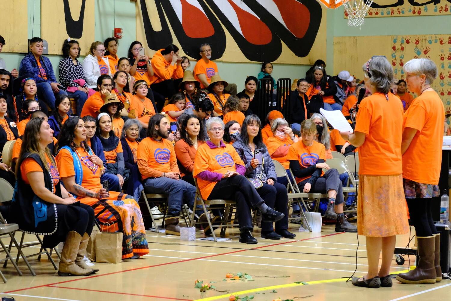Jan Bronson of Anchorage and Cathy Walling of Fairbanks, representing the Alaska Friends Conference, apologize to Alaska Native communities for the boarding schools it ran in Alaska and the United States. The apology took place at Sayéik Gastineau elementary school, the former site of a Quaker mission school in Juneau, during Orange Shirt Day, Sept. 30, 2022. (Lisa Phu/Alaska Beacon)