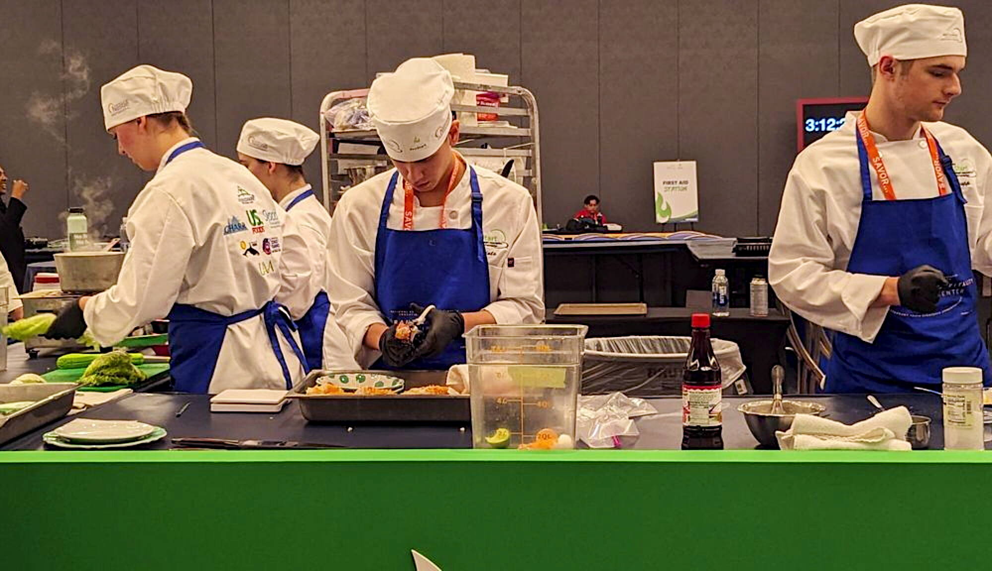 Members of the Thunder Mountain High School culinary arts team prepare their three-course meal during the National ProStart Invitational in Baltimore on April 26-28. (Photo by Rebecca Giedosh-Ruge)