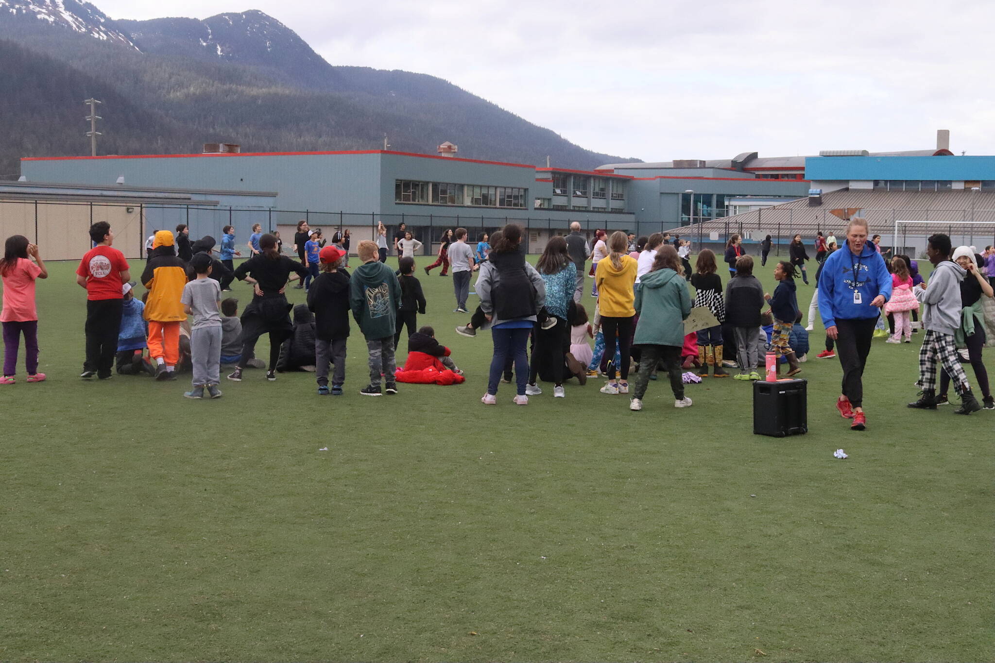 Students and staff play a kickball game on the field between the Marie Drake Building and Juneau-Douglas High School: Yadaa.at Kalé on Friday afternoon. (Mark Sabbatini / Juneau Empire)