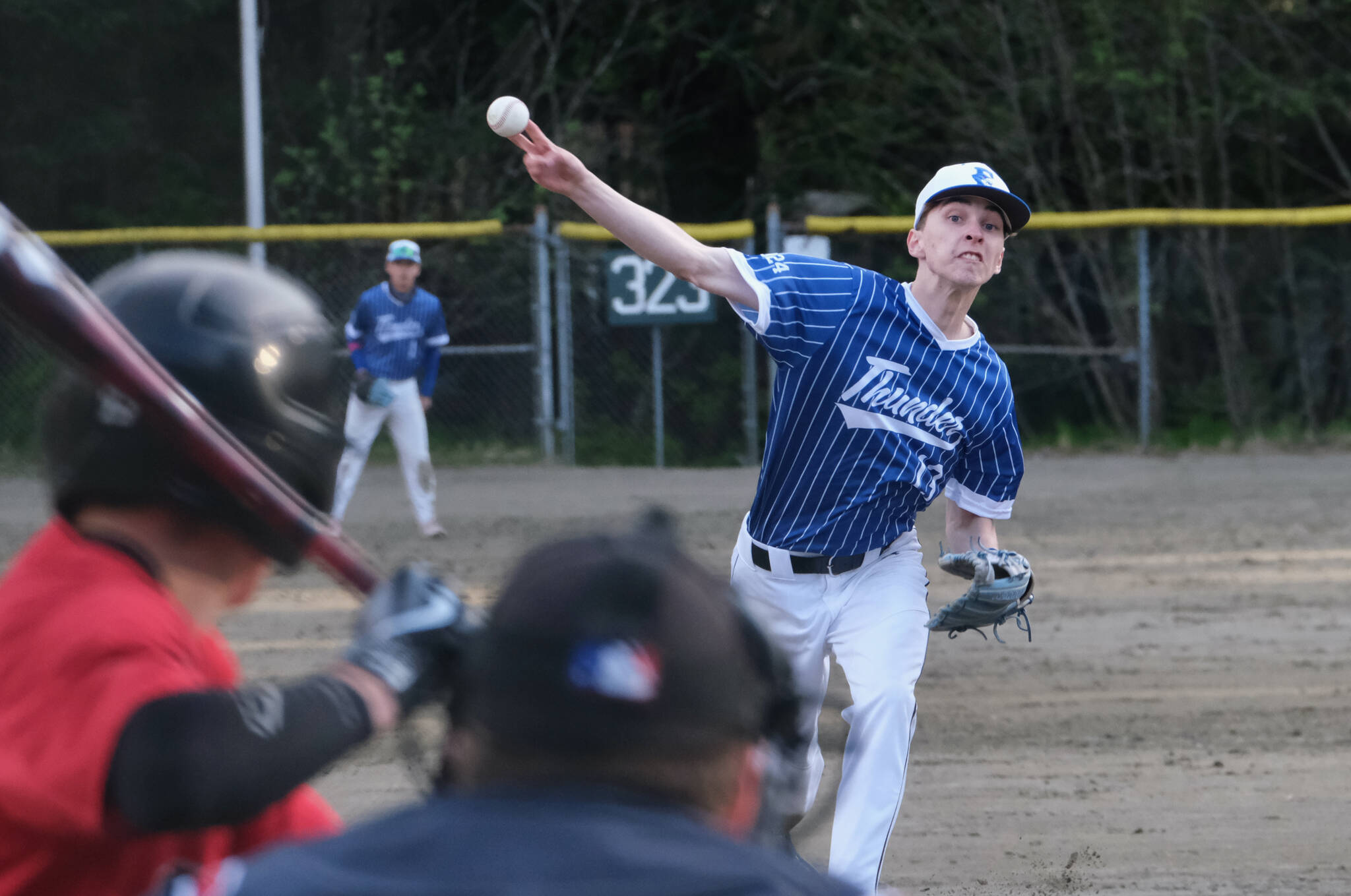 Thunder Mountain High School senior Kasen Ludeman delivers against a Juneau-Douglas High School: Yadaa.at Kalé batter during the Falcons 4-0 win over the Crimson Bears on Friday at Adair-Kennedy Field. (Klas Stolpe / For the Juneau Empire)