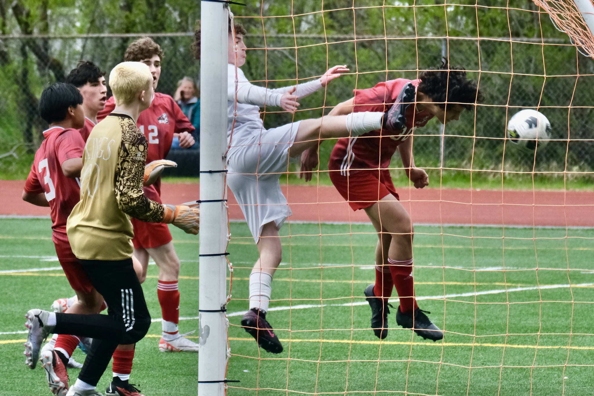 Juneau-Douglas High School: Yadaa.at Kalé senior Sonny Monsef (30) heads in a goal against Ketchikan during the Crimson Bears 2-0 title clinching win over the Kings at Adair-Kennedy Field on Saturday. (Klas Stolpe / For the Juneau Empire)