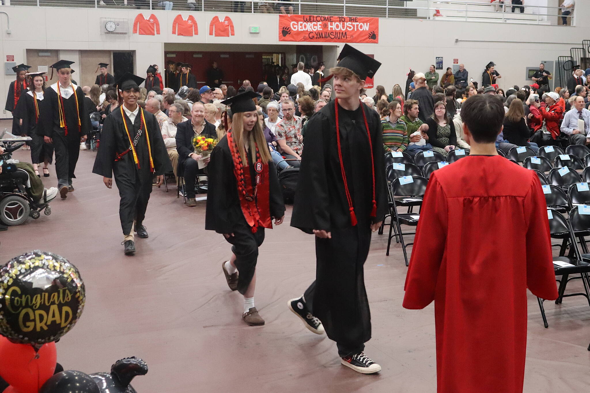 Seniors at Juneau-Douglas High School: Yadaa.at Kalé enter the gymnasium for their commencement ceremony on Sunday. (Mark Sabbatini / Juneau Empire)