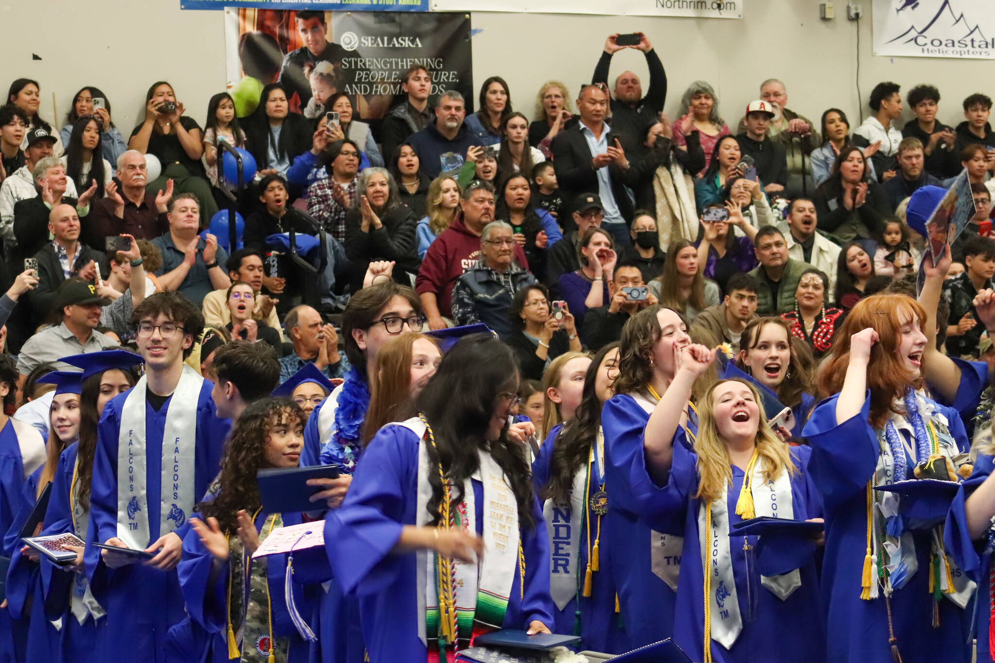 Thunder Mountain High School graduates celebrate after moving their tassels to the left, their newly received diplomas in hand, at the end of Sunday’s commencement ceremony. (Jasz Garrett / Juneau Empire)