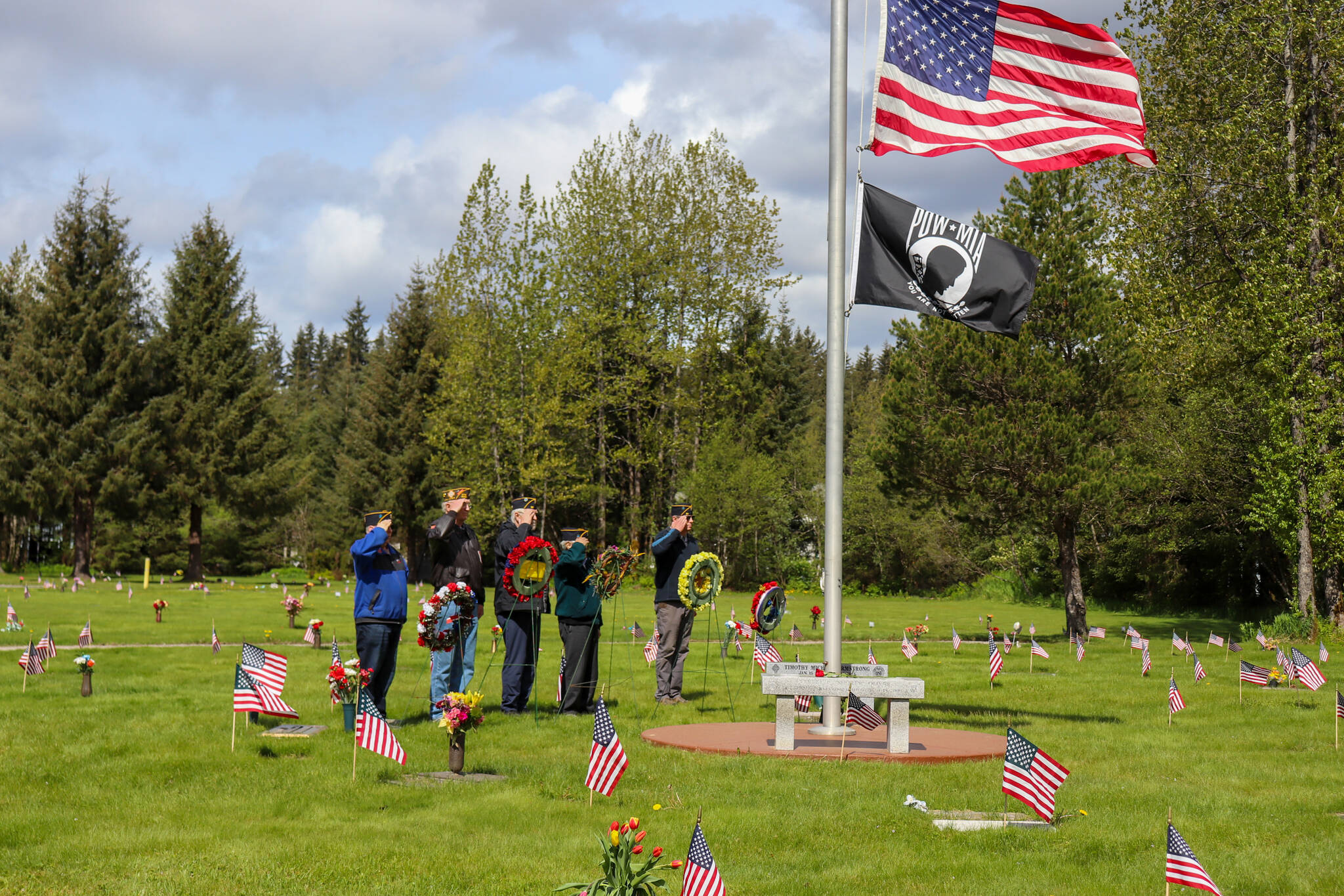 Wreath bearers present wreaths for fallen comrades, brothers and sisters in arms during a Memorial Day ceremony at Alaska Memorial Park on Monday. Laying wreaths on the graves of fallen heroes is a way to honor and remember the sacrifices made. (Jasz Garrett / Juneau Empire)