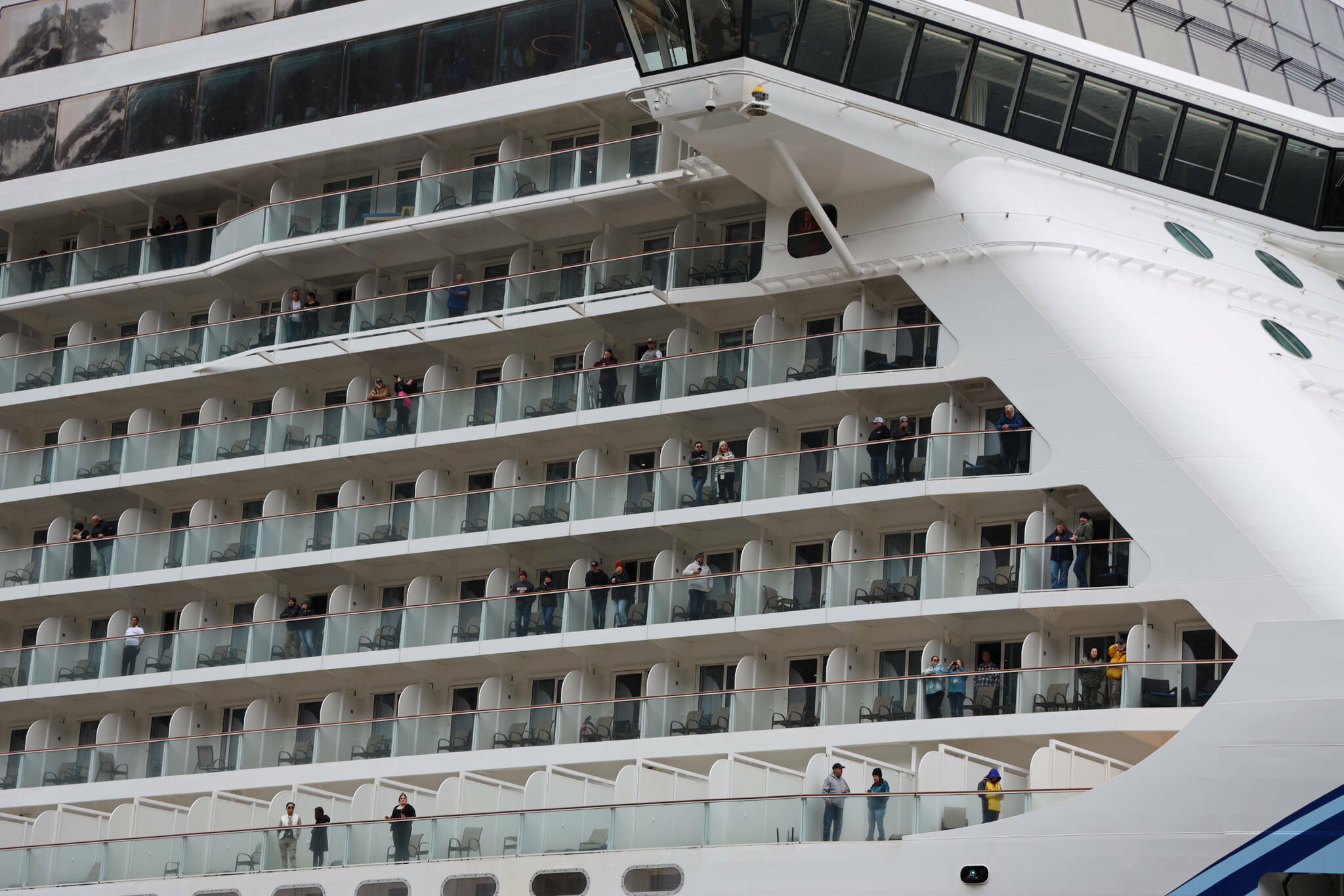 Passengers of the Norwegian Bliss look out across downtown Juneau as they wait to disembark on April 17, 2023. (Clarise Larson / Juneau Empire file photo)