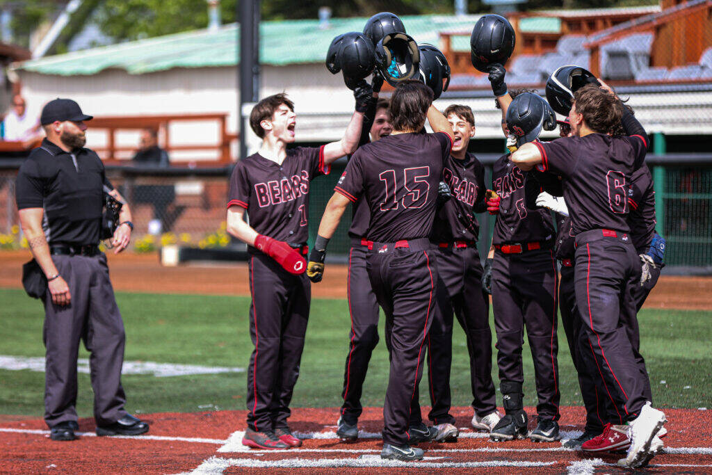 Juneau-Douglas High School: Yadaa.at Kalé’s Landon Simonson is greeted at home after hitting a grand slam on Friday during the Division I Alaska School Activities Association Baseball State Championships in Anchorage. (Stephanie Burgoon/Alaska Sports Report)