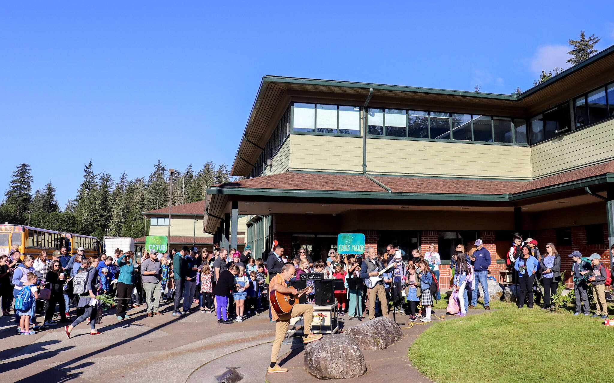 School buses arrive at the Dzantiki Heeni campus on Thursday morning as Montessori Borealis Public Alternative School begins its 33rd annual Wisdom Day. (Jasz Garrett / Juneau Empire)